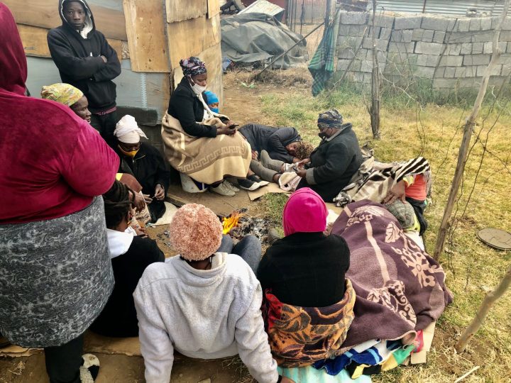 Gauteng families huddle around fire at night without food or sufficient shelter following land eviction