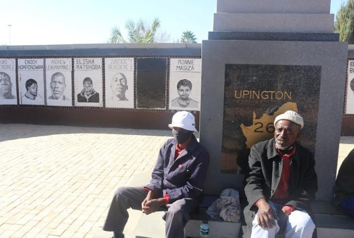 Former political prisoner scratches out his image on Upington 26 monument in protest