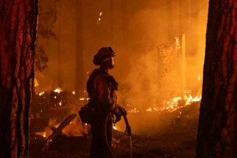 A firefighter monitors a fire as structures burn in the Indian Falls neighborhood near Crescent Mills, California on 24 July 2021. Global warming of 1.09°C has already caused widespread impacts globally. In the past several years, we’ve seen enormous wildfires sweep across Australia, Chile, the US and Greece. (Photo: David Odisho / Bloomberg via Getty Images)