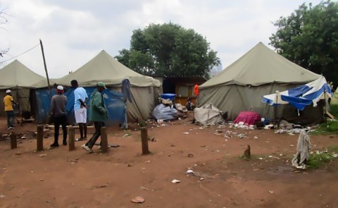 From bad to worse: Foreign nationals evicted from Johannesburg inner city relocated to squalid shelter