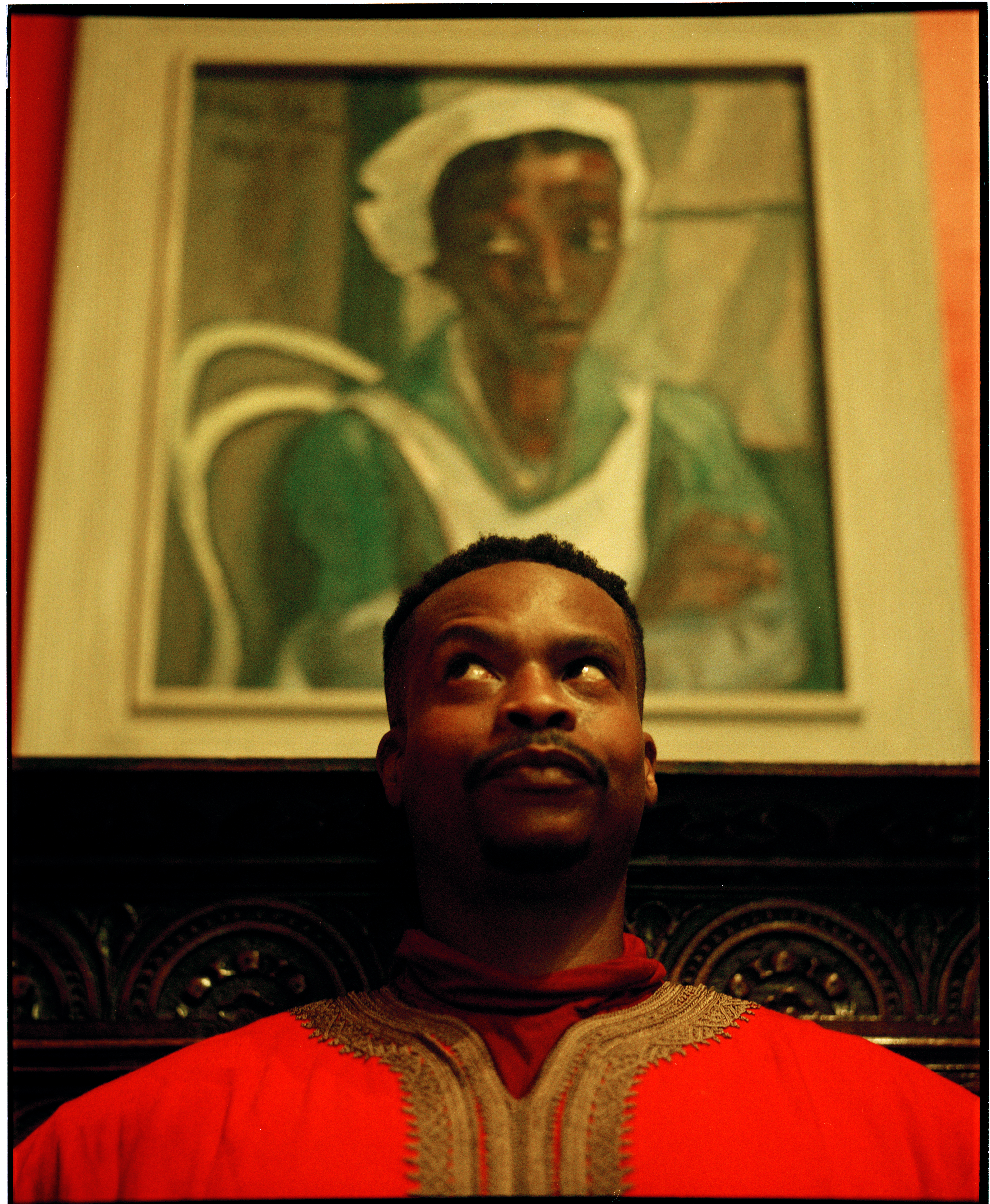 Athi-Patra Ruga stands in front of "Maid in Uniform" by Irma Stern.