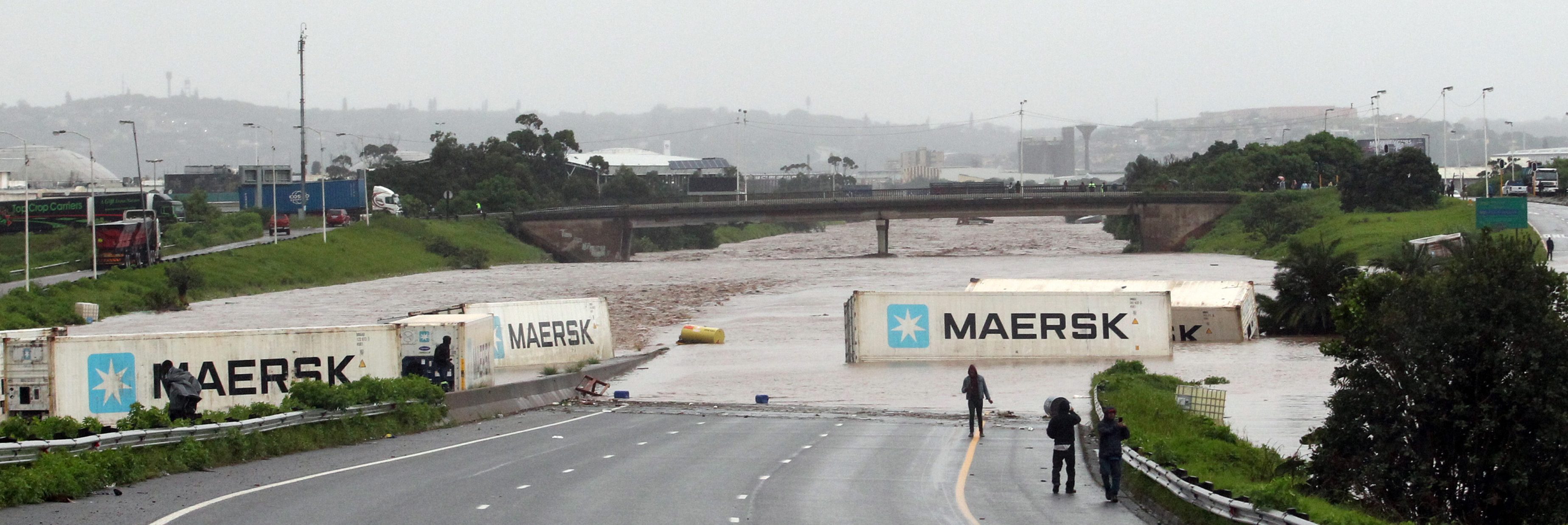 Containers are scattered across a road after the heavy rain in KZN