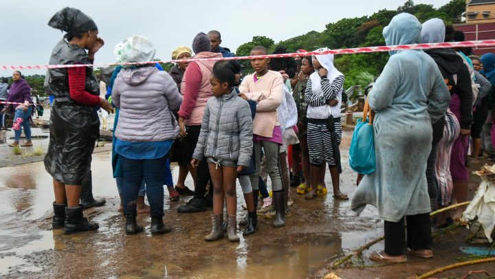 Residents from the informal settlement between M19 and Quarry road line up for food after the heavy rain