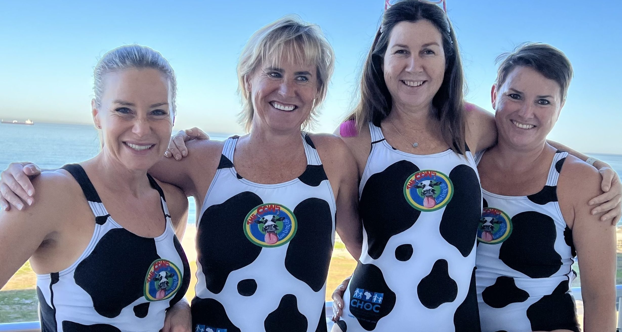 Karen Jankelow, Sue Rider, Michelle Blaauw and Gráinne Formby pose in their matching swimsuits.