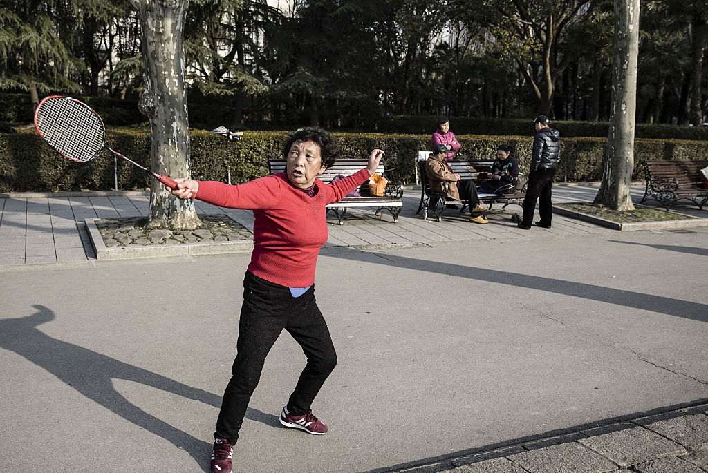 A woman plays badminton at Fuxing Park in Shanghai, China, on Tuesday, Feb. 9, 2016.