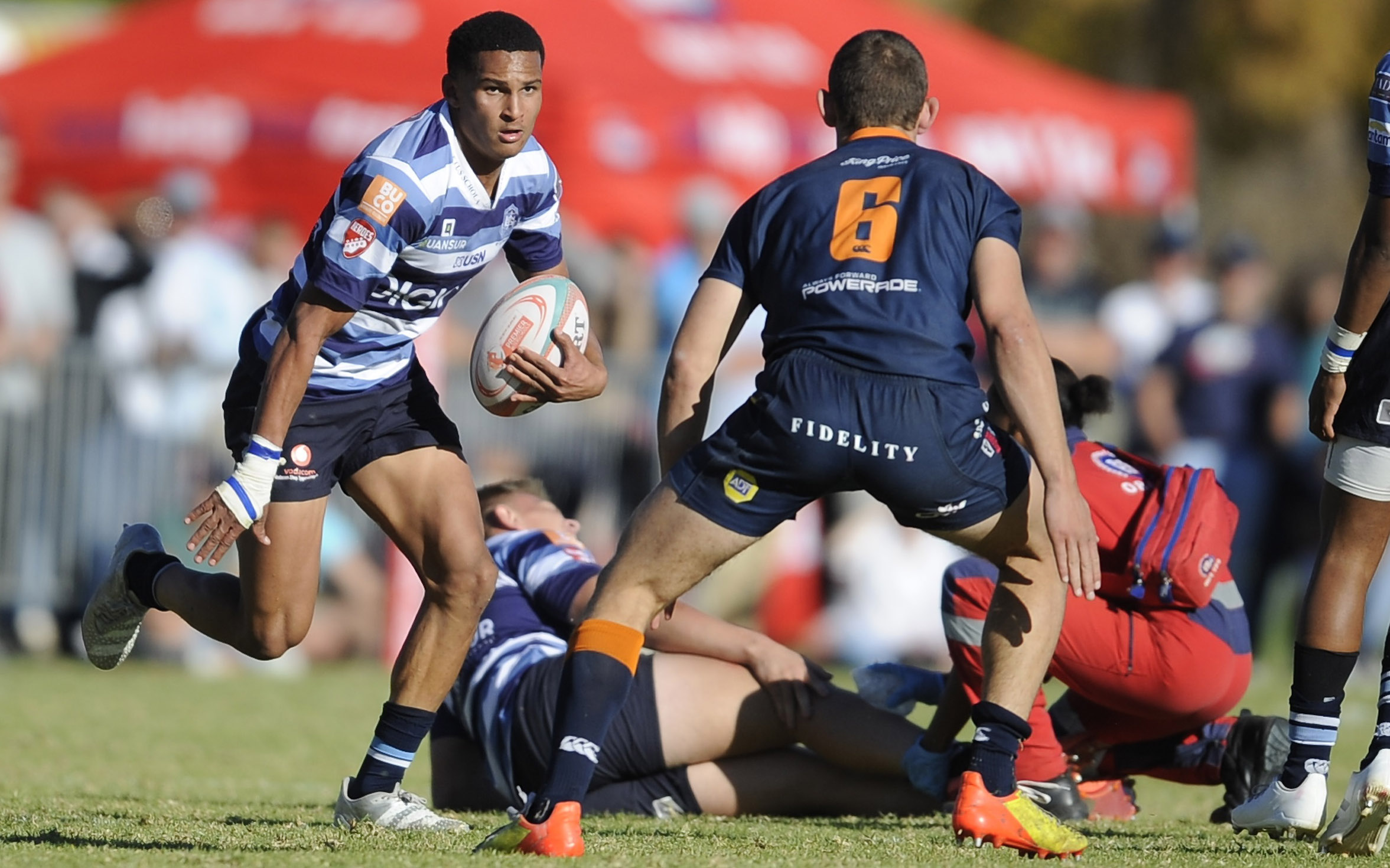Shah Jehaan de Jongh of Paarl Boys High runs with the ball as Jean-Henri Smit of Grey College gets ready to tackle