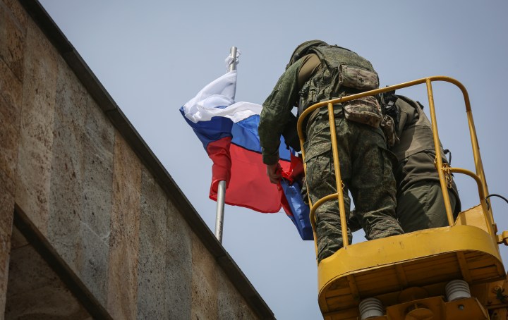Russian proxies claim control of key town in east Ukraine