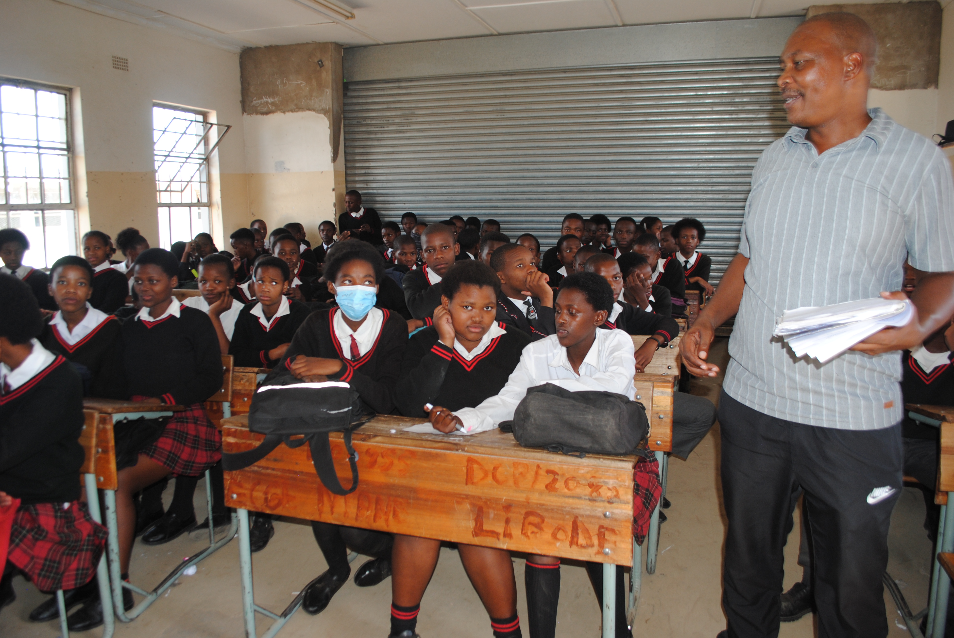 The deputy principal at Ntapane Junior Senior Secondary School attempts to teach an overcrowded classroom
