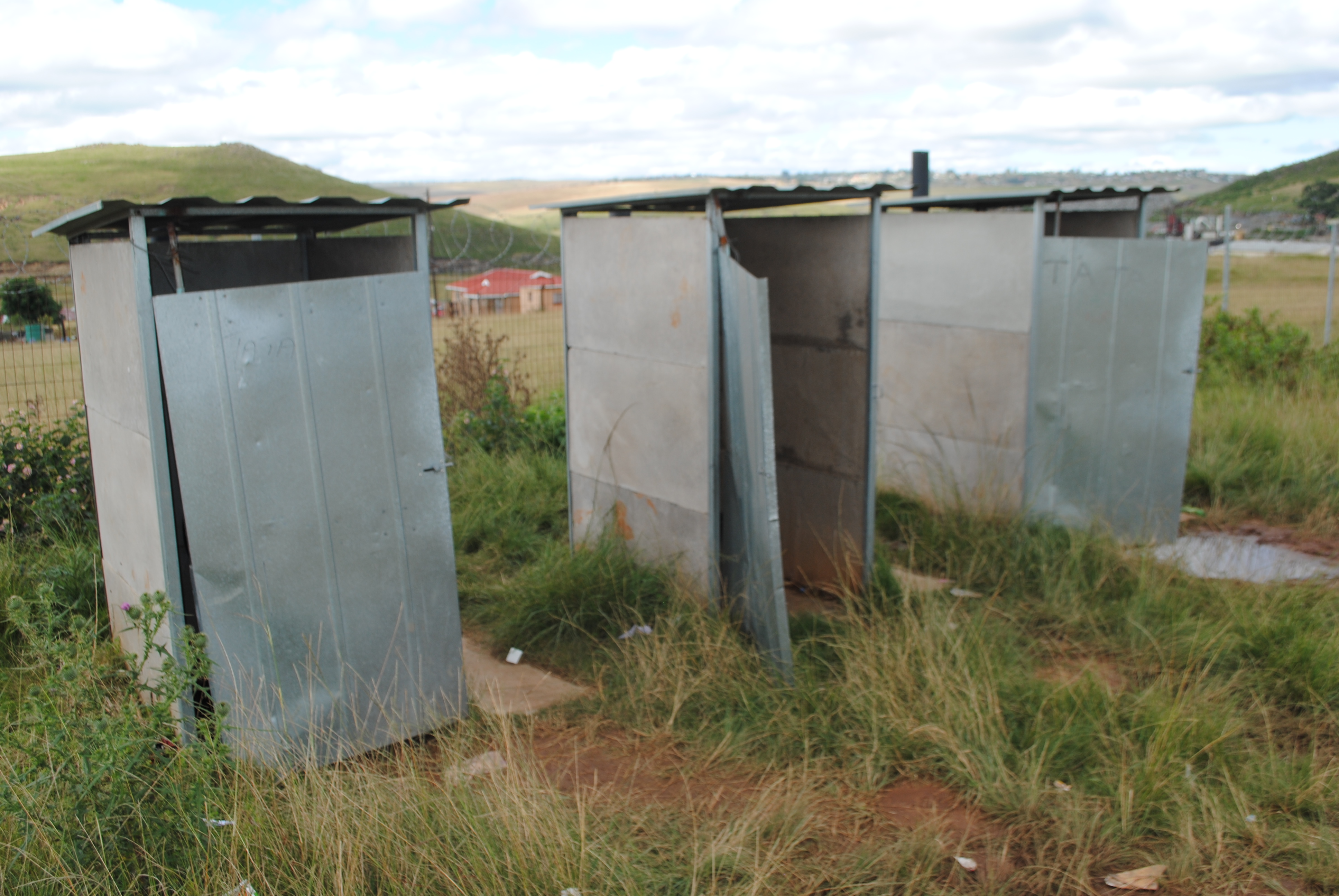 Eastern Cape Schools - a toilet block with broken cubicle doors
