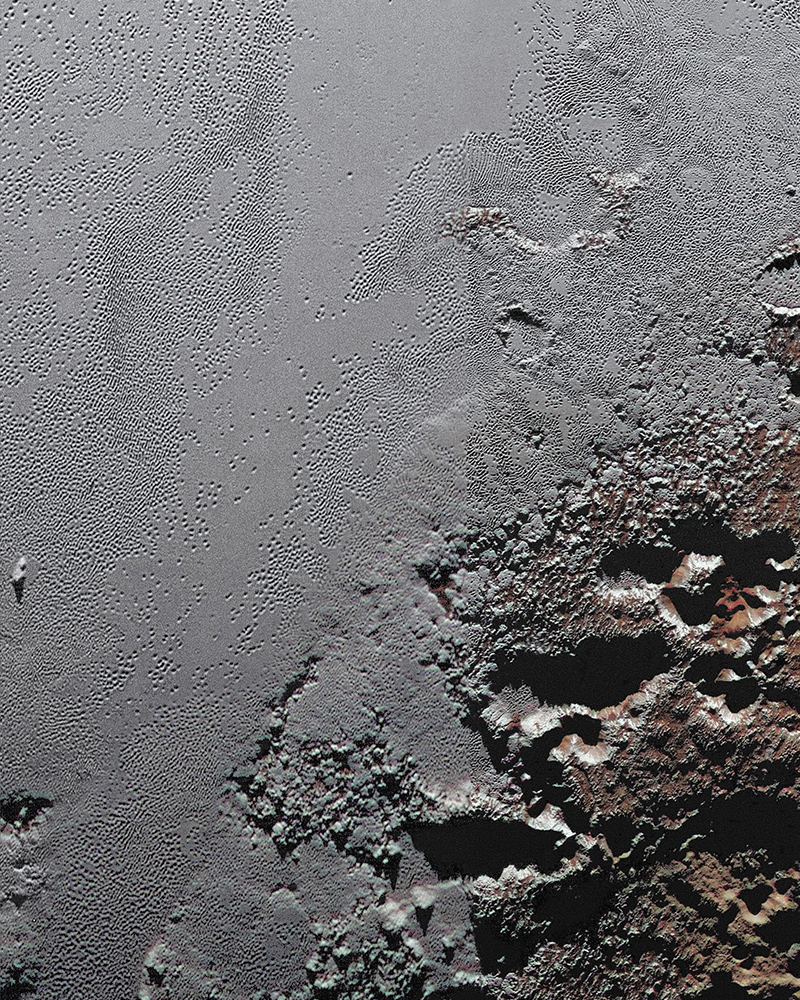 Pluto's great ice plains, where at lower right the plains border rugged, dark highlands informally named Krun Macula.