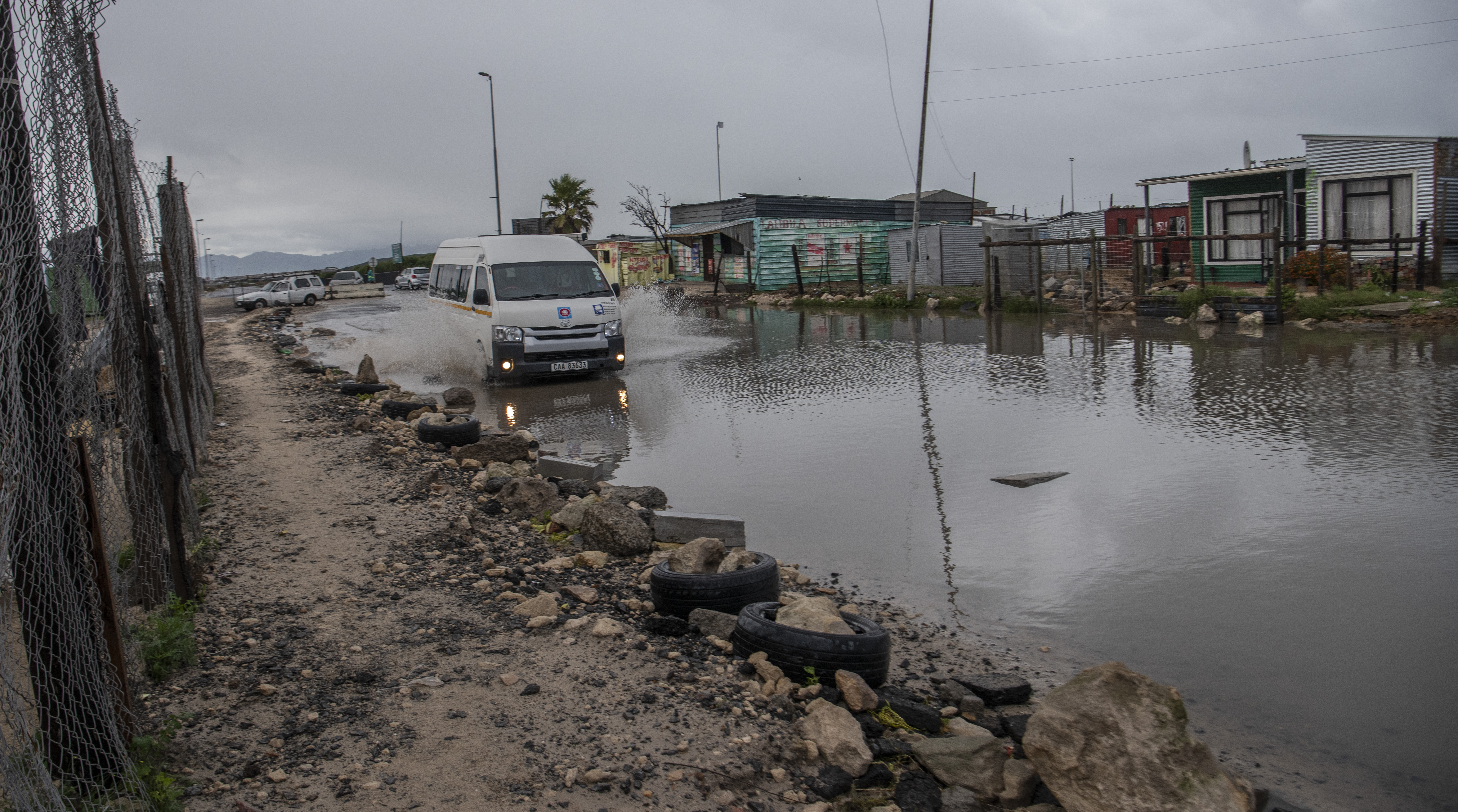 A taxi attempts to make its way through the flooded streets of Khayelitsha