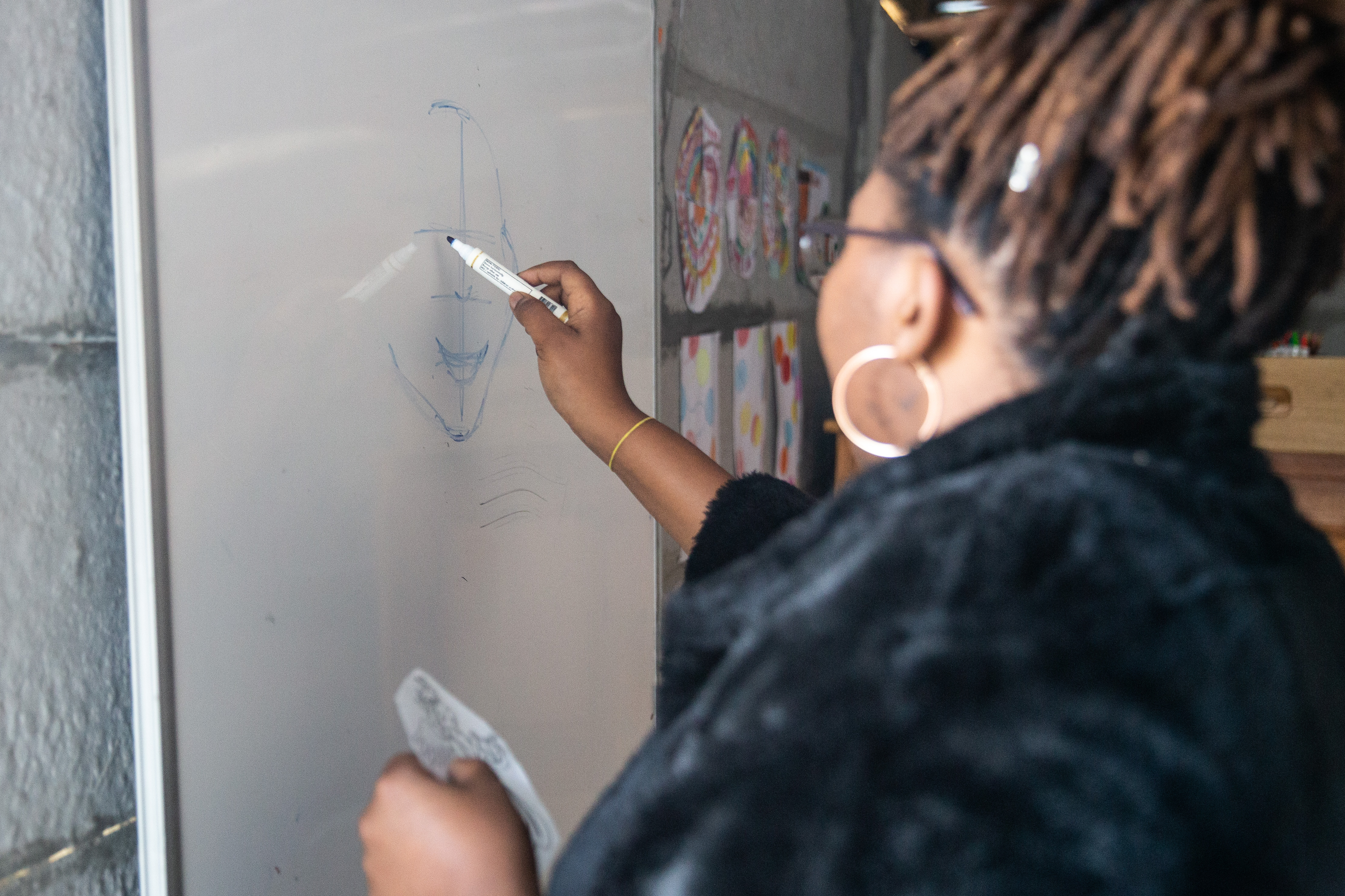 Nwabisa Nkonyana teaches proportions on a white board