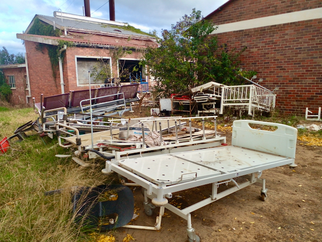 A view of hospital beds and broken furniture dumped on the grounds of Fort Beaufort Provincial Hospital