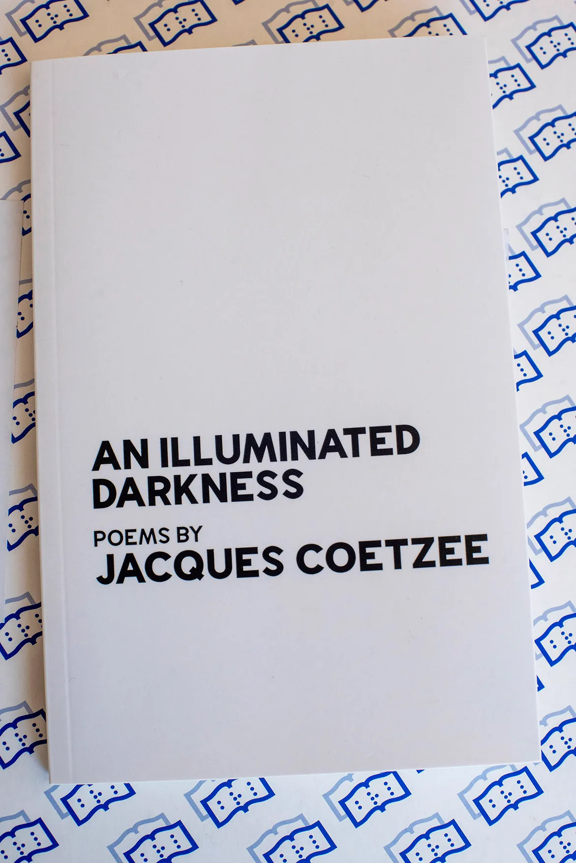 A print copy of Jacques Coetzee's Ingrid Jonker Prize winning collection of poems, 'An Illuminated Darkness'. 21 July 2022.