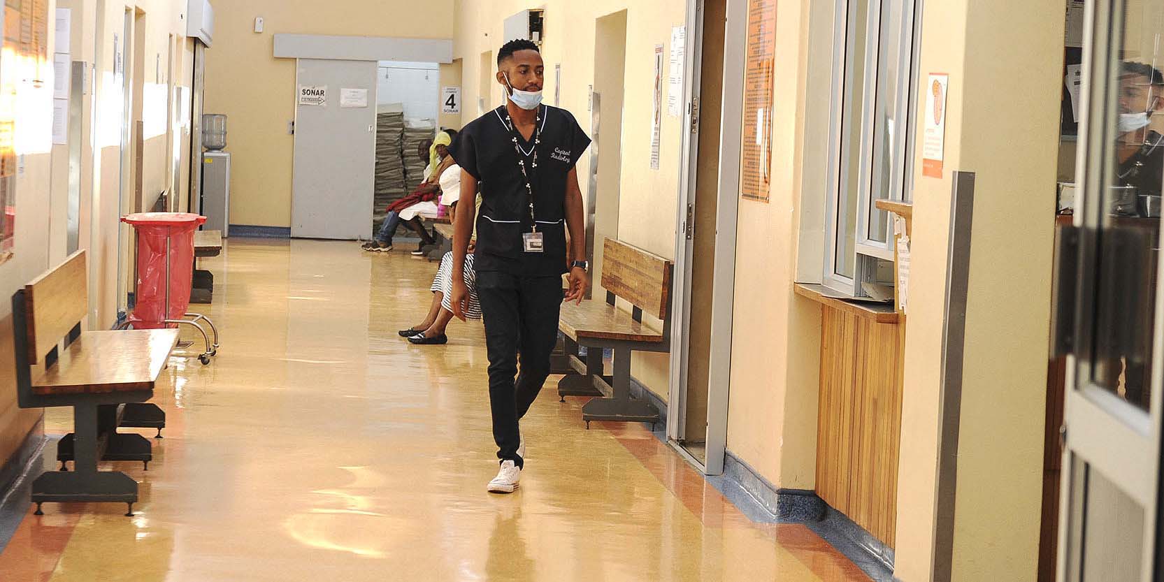 A hospital staff member in a hospital corridor.