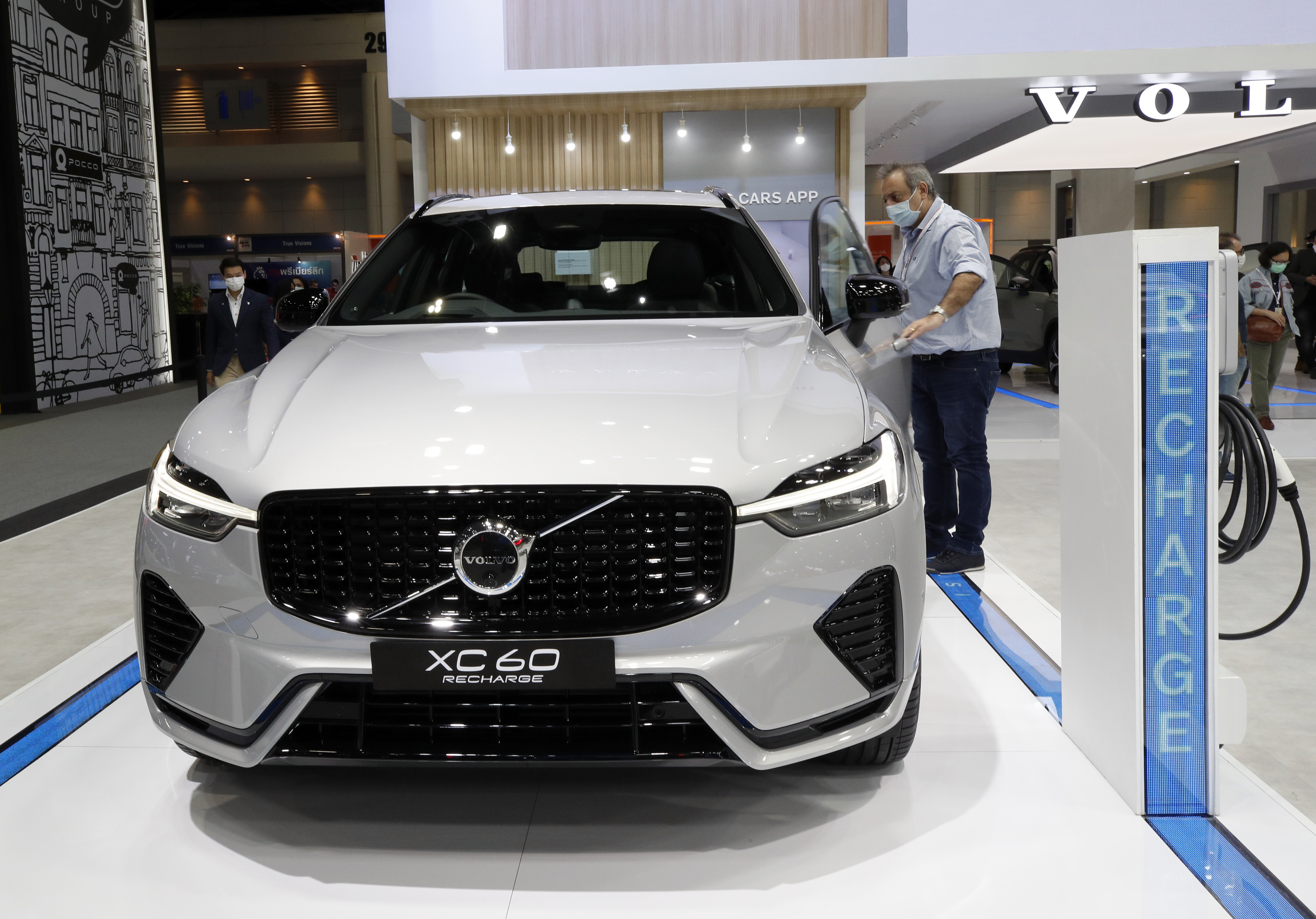 A visitor inspects a Volvo XC60 Recharge Plug-in Hybrid SUV electric car displaying at the 38th Thailand International Motor Expo 2021 in Bangkok, Thailand, 30 November 2021. 