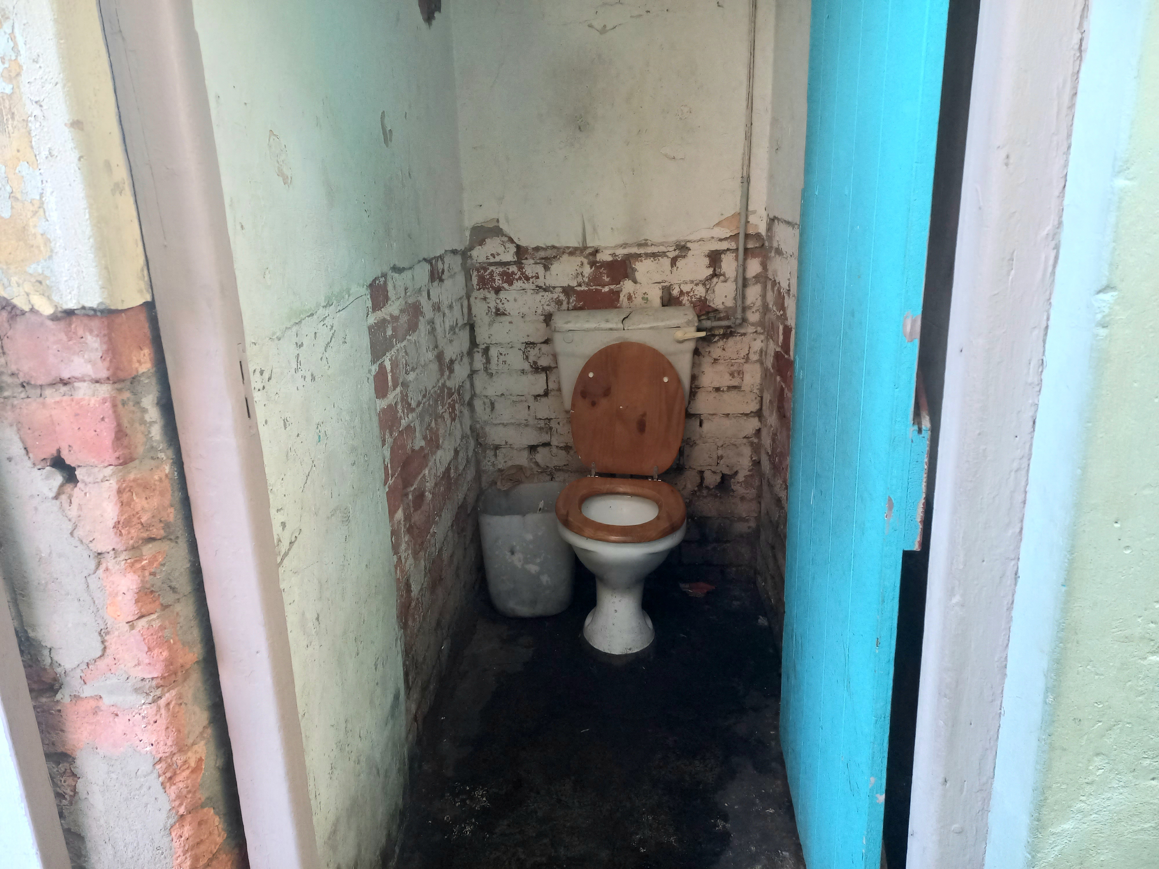 A view of a single toilet that 25 backyarders have to share. 