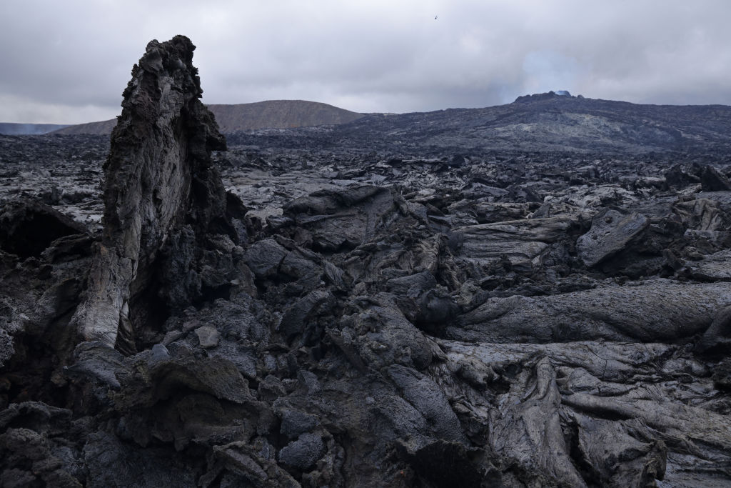 The still-hot, solid lava field lies under Fargradalsfjall volcano on August 19, 2021 near Grindavik, Iceland. The volcano, which erupted in March of this year and is located only a short drive from Iceland's main international airport, has become a major tourist attraction. Image: Sean Gallup / Getty Images