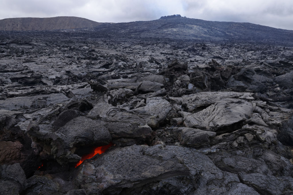 The still-hot, solid lava field lies under Fargradalsfjall volcano on August 19, 2021 near Grindavik, Iceland. The volcano, which erupted in March of this year and is located only a short drive from Iceland's main international airport, has become a major tourist attraction. Image: Sean Gallup / Getty Images