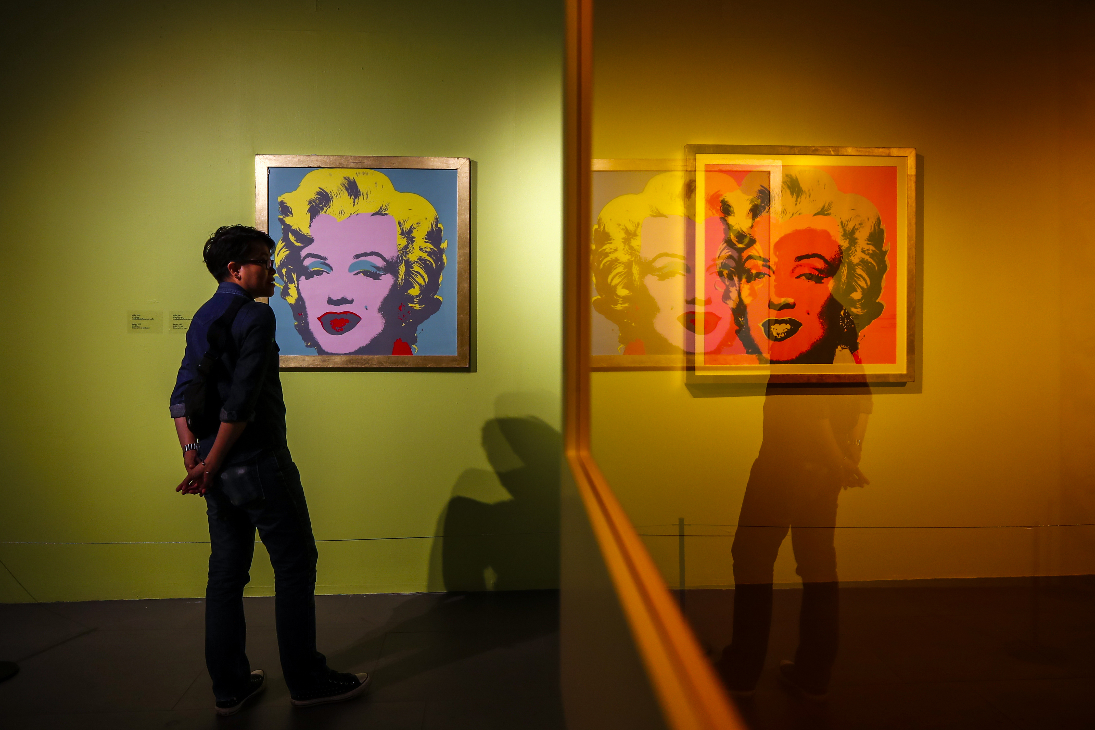 A woman looks at the 'Marilyn Monroe' series during the inauguration of the Andy Warhol Pop Art exhibit at the RCB Galleria in Bangkok, Thailand, 11 August 2020. 