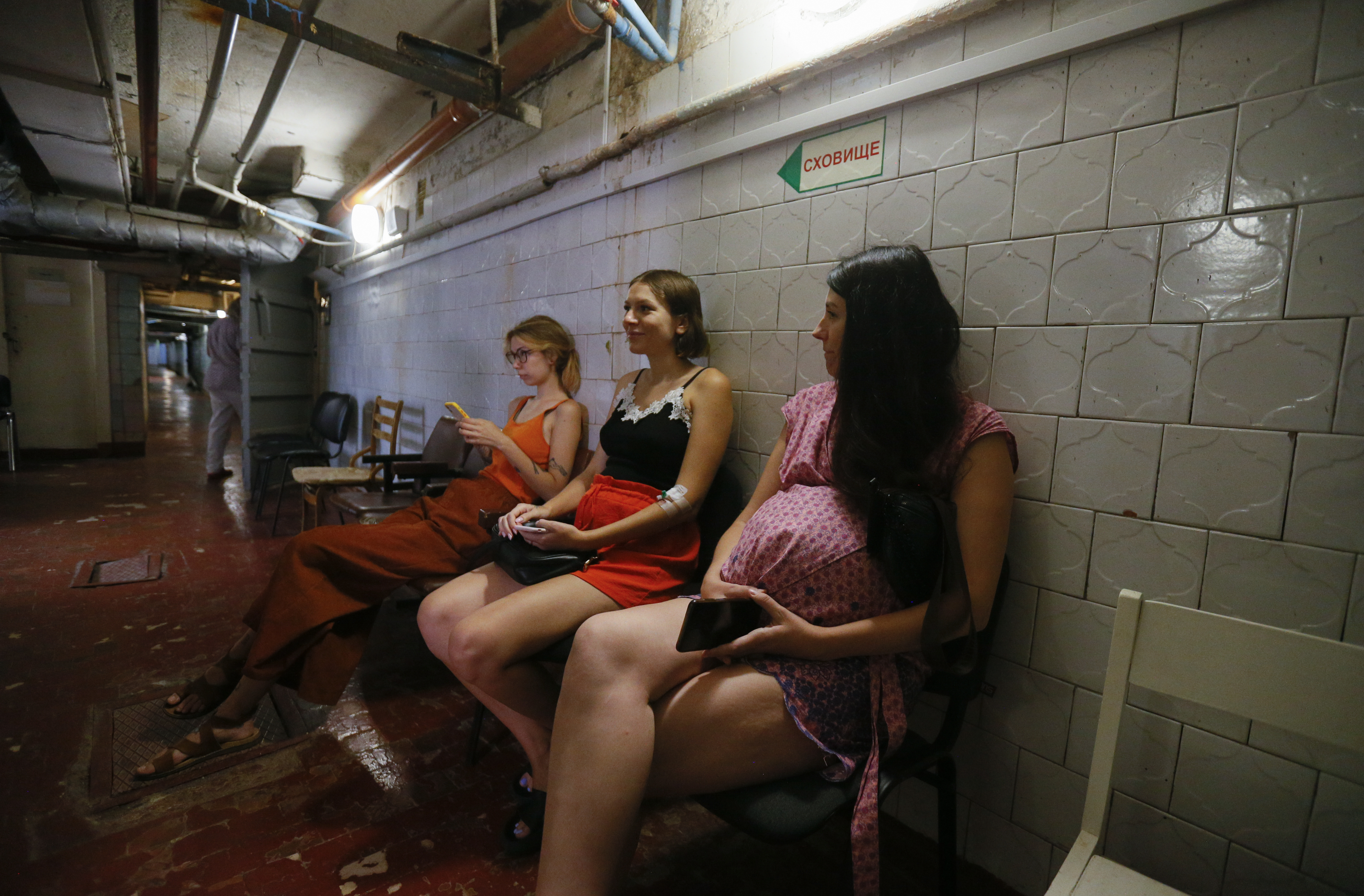 Pregnant women sit in a bomb shelter organized below a children hospital during an air-raid alarm in Odesa, Ukraine, 22 August 2022. EPA-EFE/STRINGER