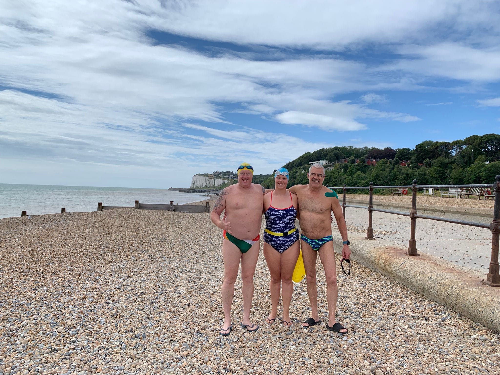 Kat Persson, Jon Vickers and Ross Duncan standing on Dover beach for a training swim.