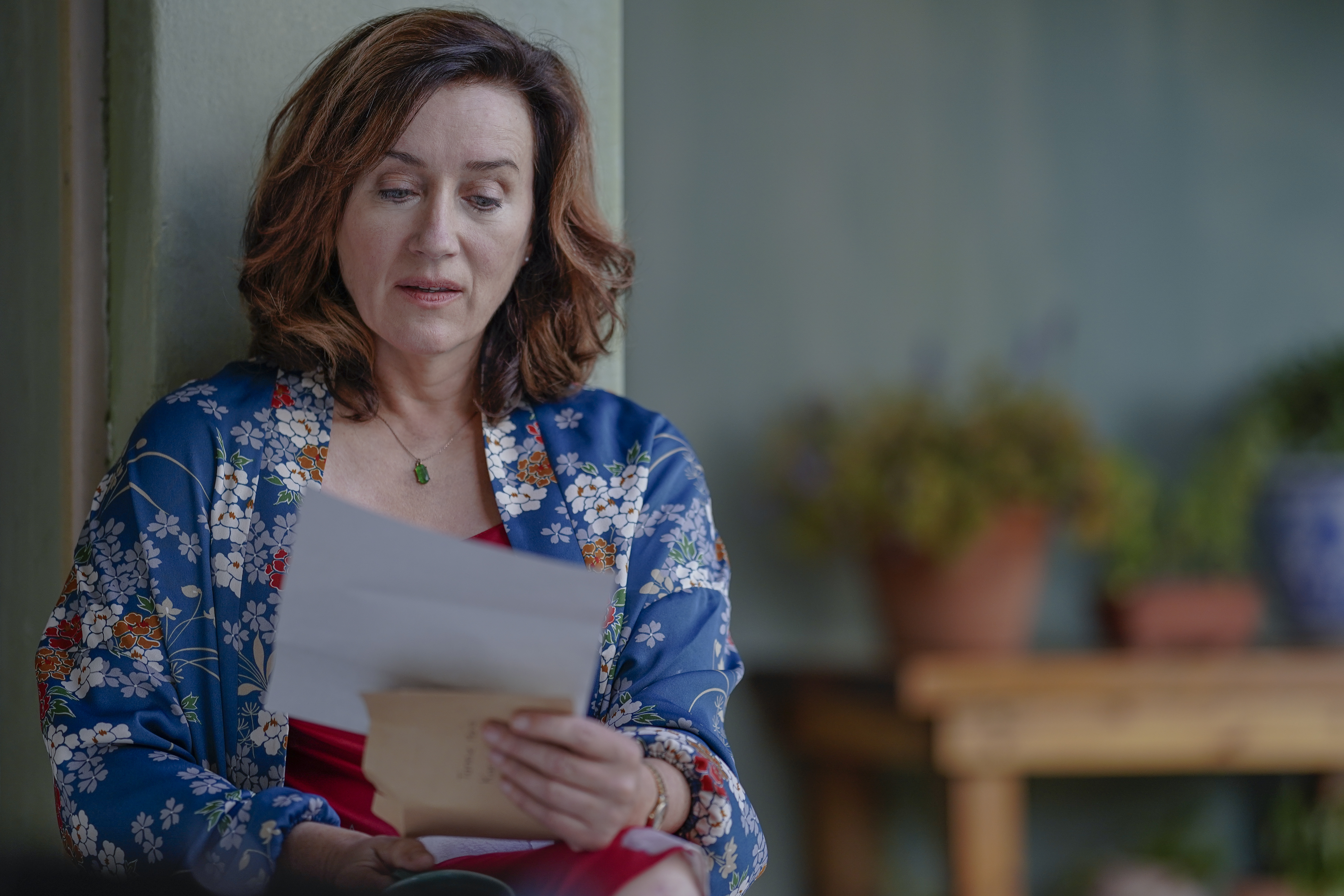 Maria reading a letter in 'Recipes for Love and Murder'. Image: Patrick Toselli/AcornTV