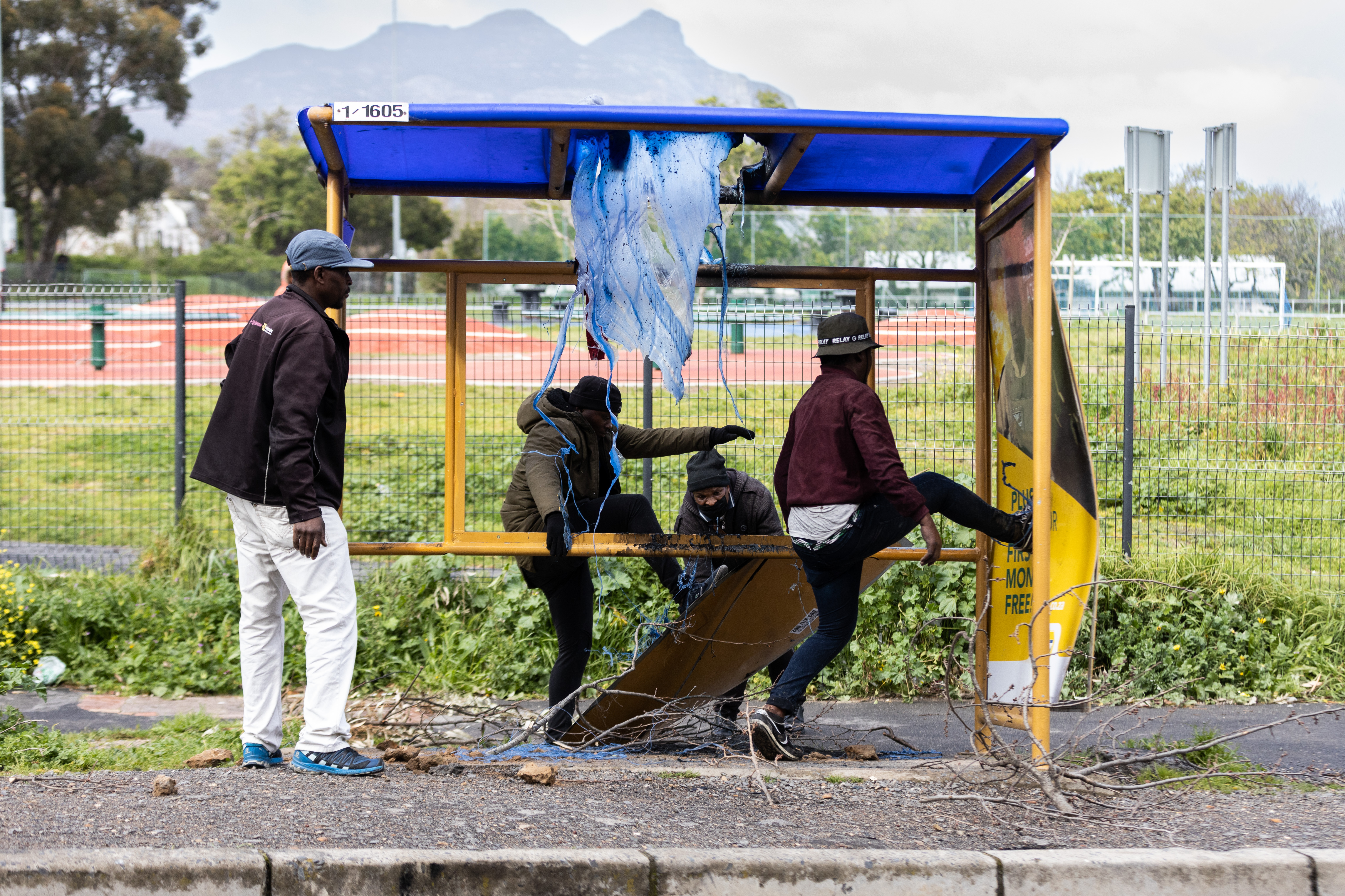 Taxi drivers vandalising a bus stop