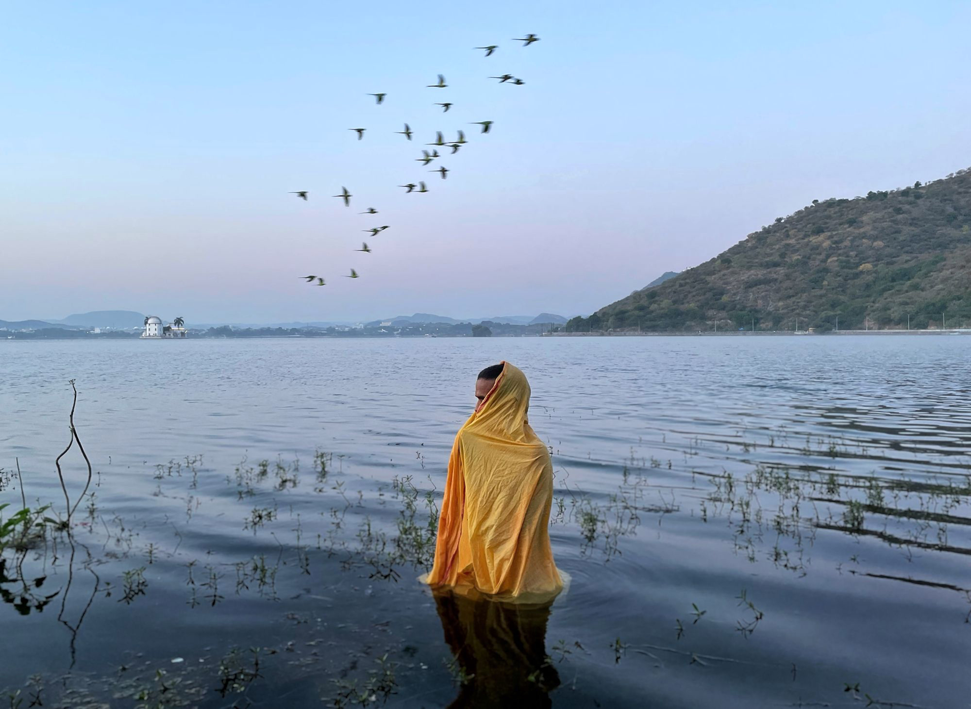 'Faith above everything'. A man standing in freezing cold water waiting for Sun God to arrive during Chatth Puja Festival. © Amish Jain/TNC Photo Contest