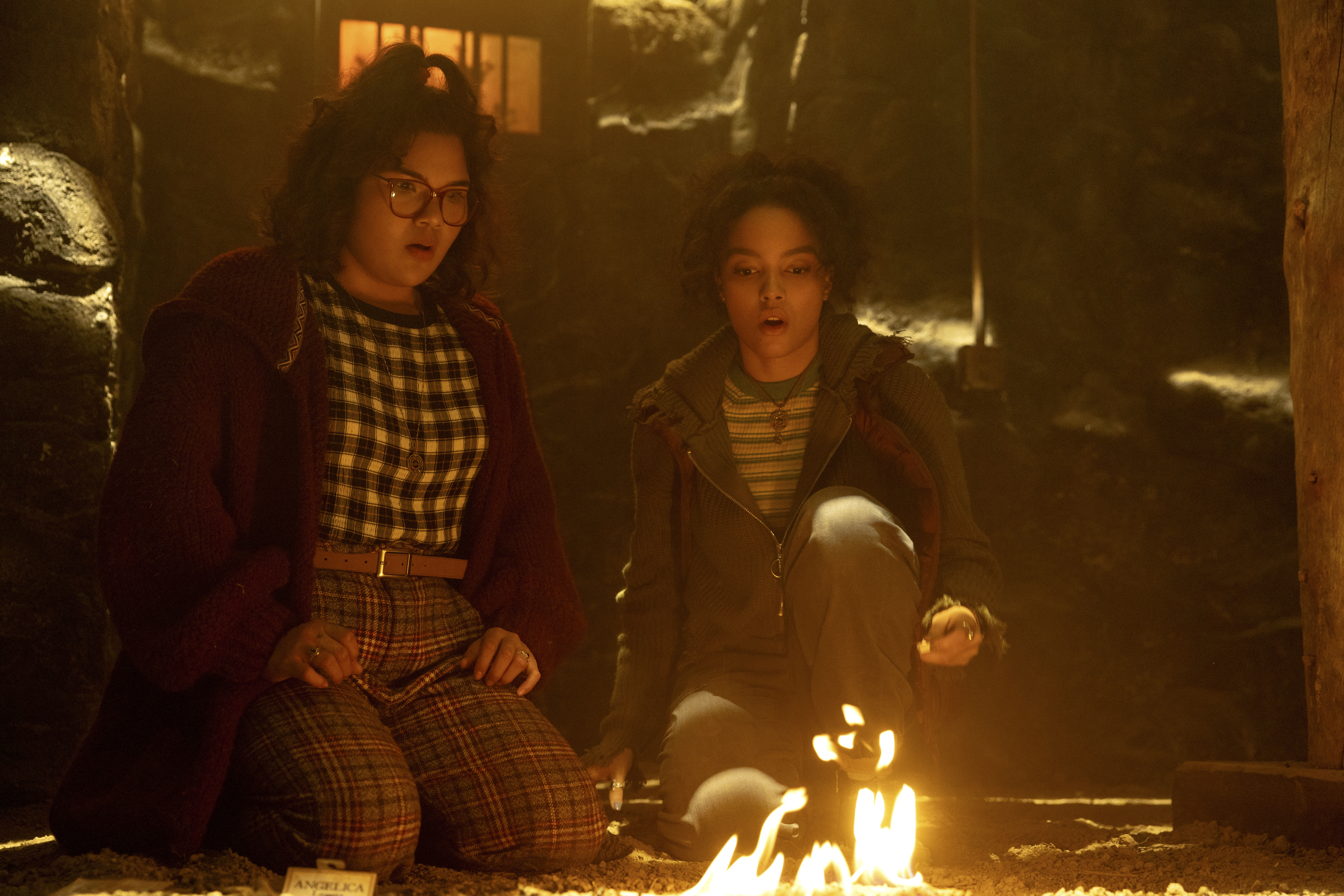(L-R): Belissa Escobedo as Izzy and Whitney Peak as Becca in HOCUS POCUS 2, exclusively on Disney+. Photo by Matt Kennedy. © 2022 Disney Enterprises, Inc. All Rights Reserved.