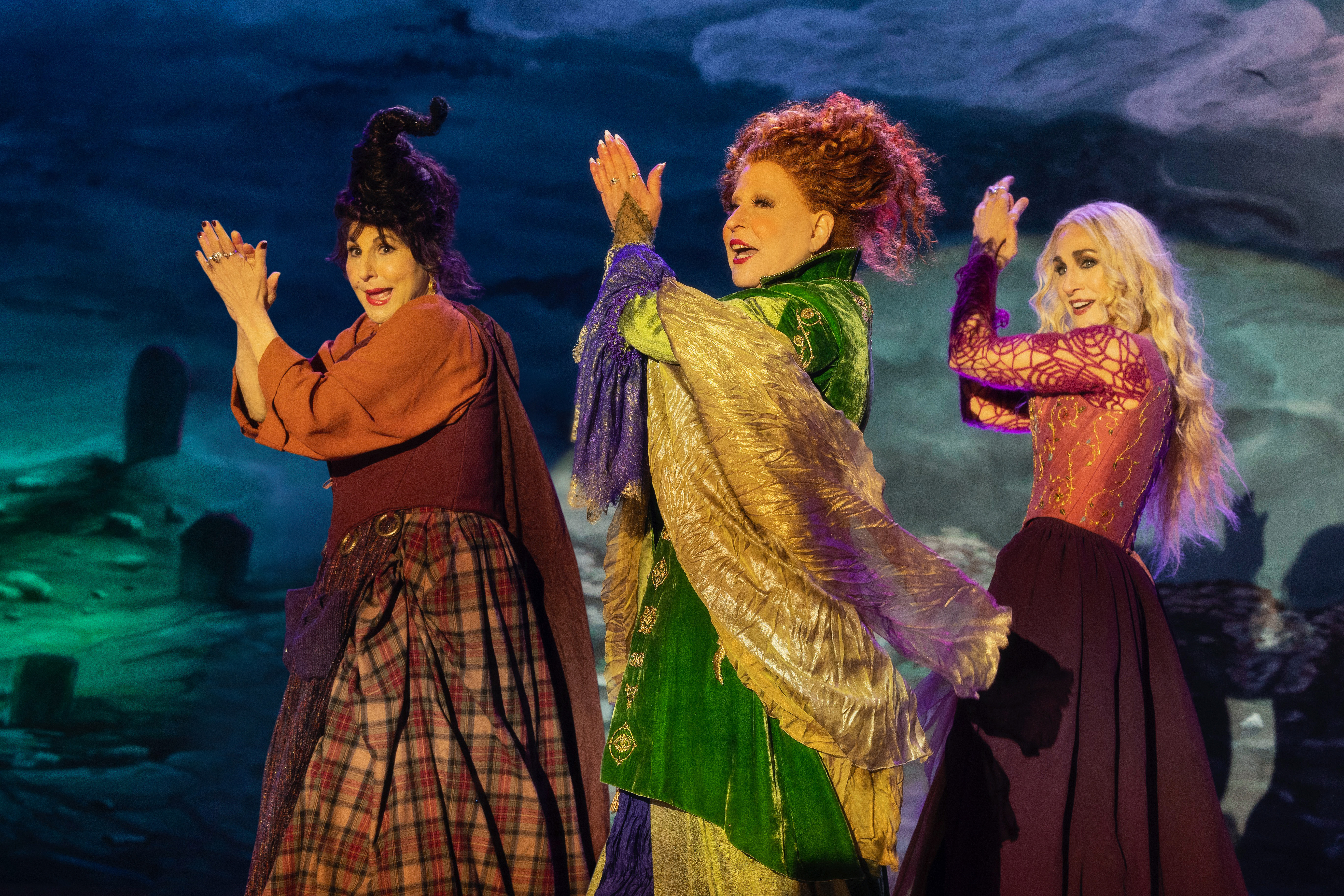 (L-R): Kathy Najimy as Mary Sanderson, Bette Midler as Winifred Sanderson, and Sarah Jessica Parker as Sarah Sanderson in HOCUS POCUS 2, exclusively on Disney+. Photo by Matt Kennedy. © 2022 Disney Enterprises, Inc. All Rights Reserved.