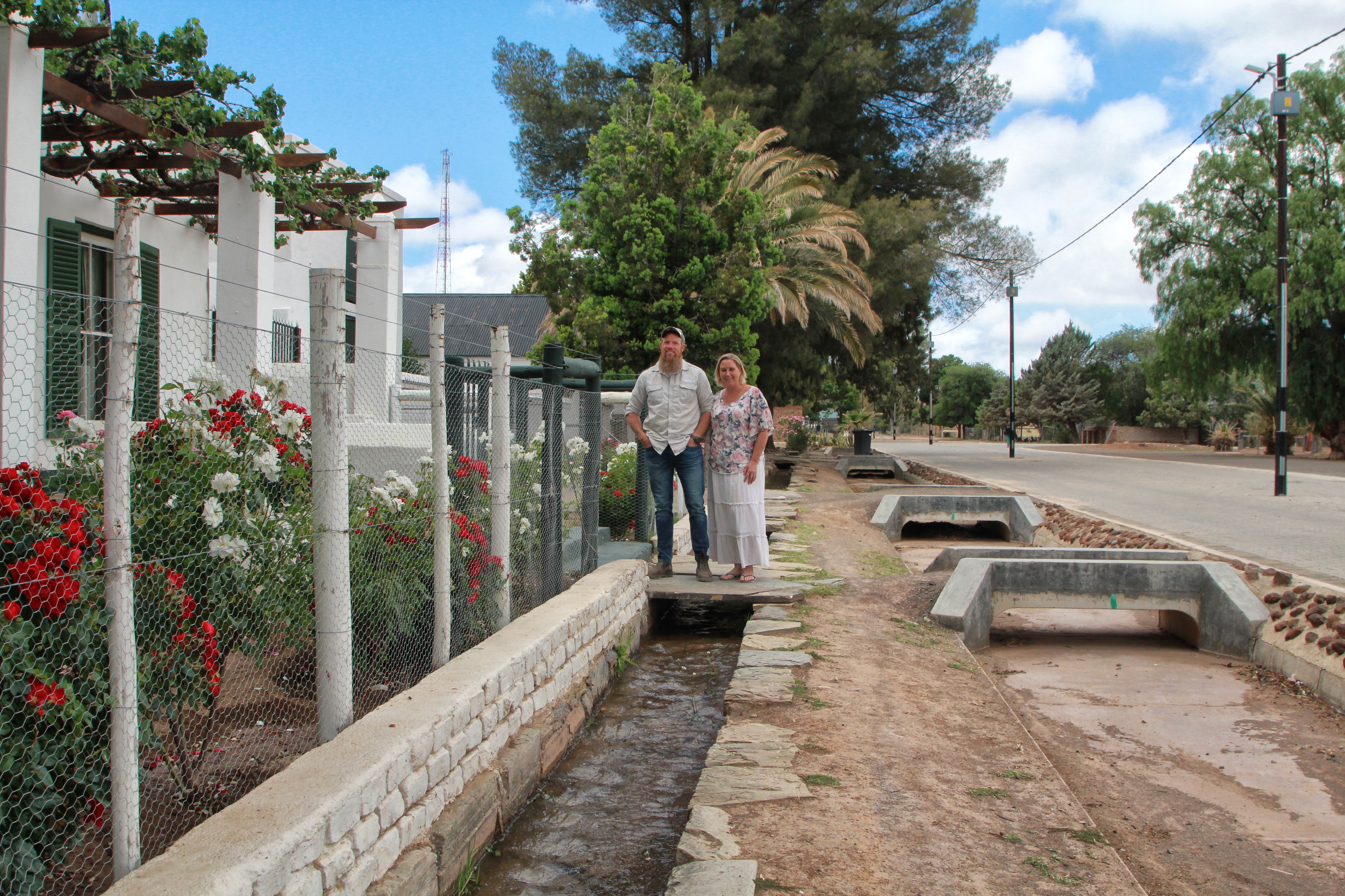 Jan-Hendrik Swiegers, his wife Michelle and the gurgling water furrow in front of their guesthouse.