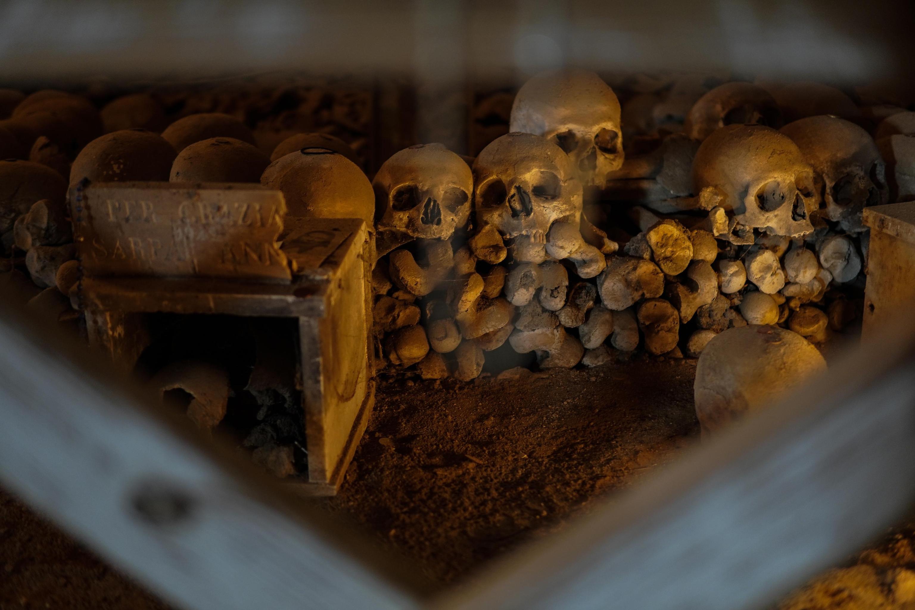epa07966669 Skulls and bones inside the Fontanelle cemetery in Naples, Italy, 02 November 2019. The Fontanelle cemetery is the epicenter of what is known as 'The Neapolitan Cult of the Dead' or 'The Neapolitan Skull Cult'. It is a vast underground ossuary located in a cave in the tuff hillside at the heart of the Sanita' quarter, once used to bury the corpses of people for whom there was no room in the public graves at the churches within the city. Before it became a place of popular worship and the focal point for various rites, legends and tales of miracles. The anonymous bones are the object of great devotion and have always been referred to by the Neapolitans as the anime 'pezzentelle', or 'little wretches', thus creating a link between the living and the dead. EPA-EFE/CESARE ABBATE