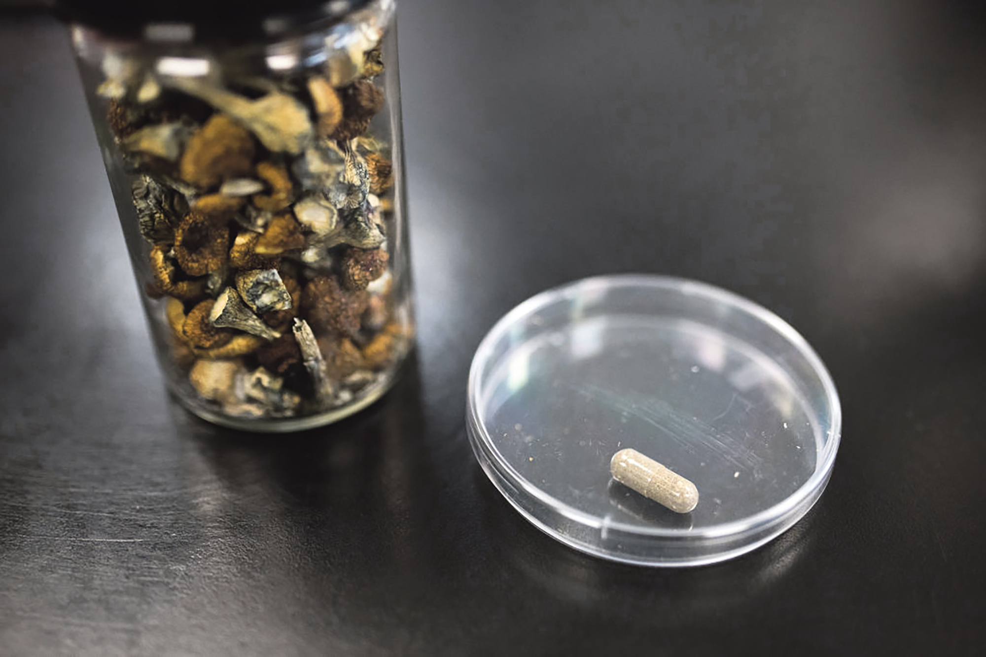 A container of Psilocybe mushrooms, left, alongside the final product in pill form at the Numinus Bioscience lab in Nanaimo, British Columbia, Canada, on Wednesday, Sept. 1, 2021. Numinus Wellness Inc, a mental health care company specializing in psychedelic-assisted therapies was the first public company in Canada to harvest the first legal batch of mushrooms from the Psilocybe genus last year. Photographer: James MacDonald/Bloomberg via Getty Images