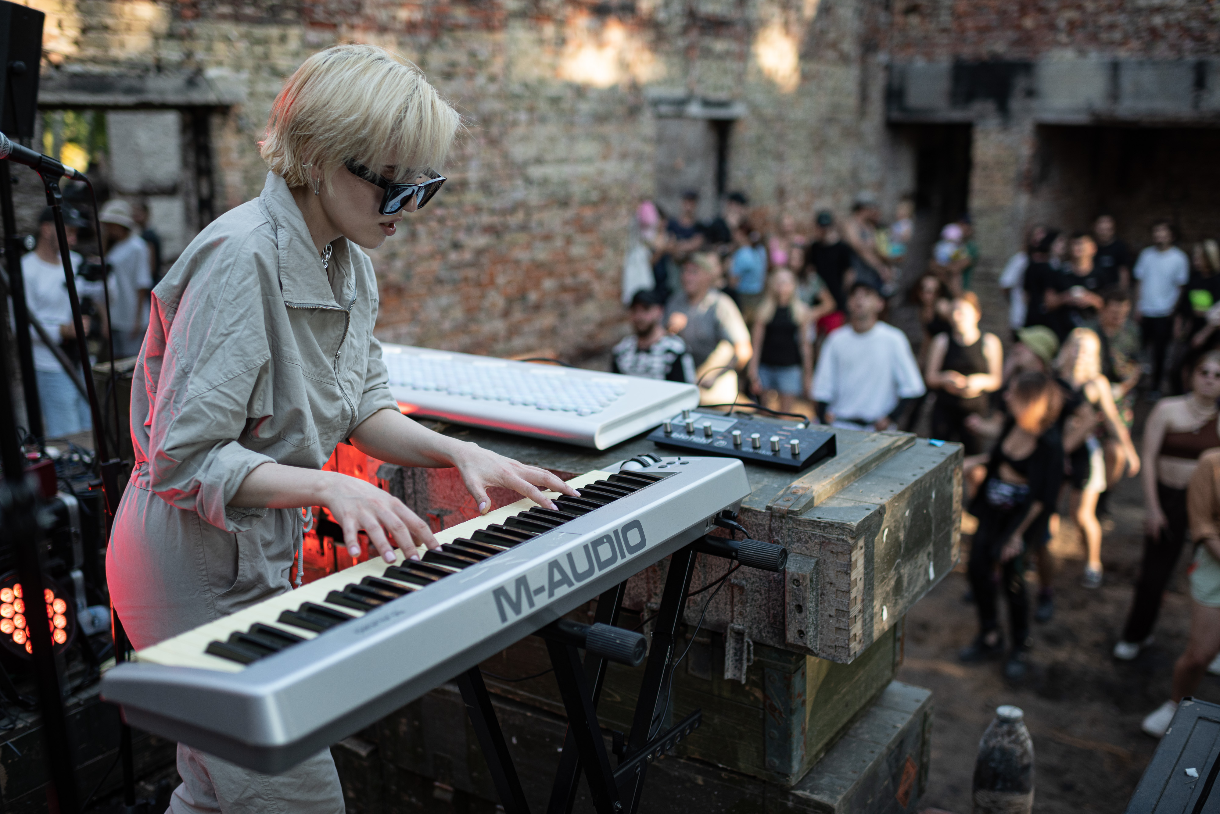 YAHIDNE, UKRAINE - JULY 23: A singer plays the synthesizer and sings inside the Yahidne House of Culture during the Rave Cleanup event on July 23, 2022 in Yahidne, Chernihiv Region, Ukraine. Repair Together is a volunteer initiative to rebuild villages that were damaged during the Russian invasion of Ukraine that began February 24th, 2022. (Photo by Alexey Furman/Getty Images)