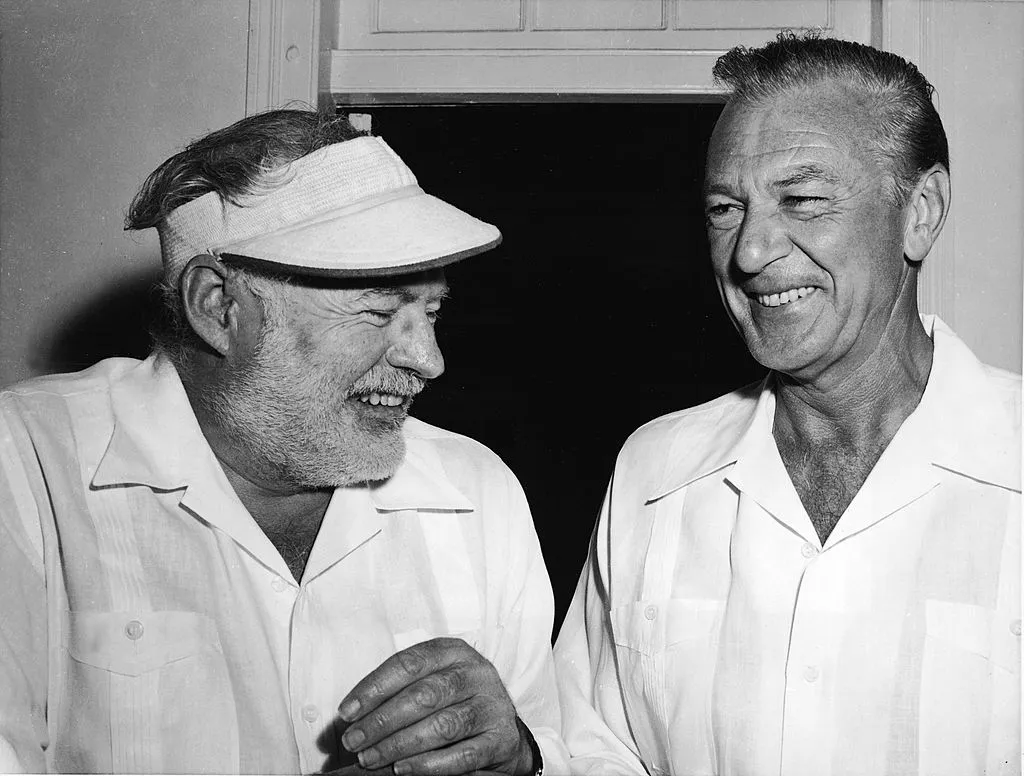 American author Ernest Hemingway (1899 - 1961) (left) shares a laugh with actor Gary Cooper (1901 - 1961) in Havana, Cuba, 1956. Cooper starred in the film adaptation of Hemingway's novel, 'For Whom The Bell Tolls.' (Photo by Hulton Archive/Getty Images)