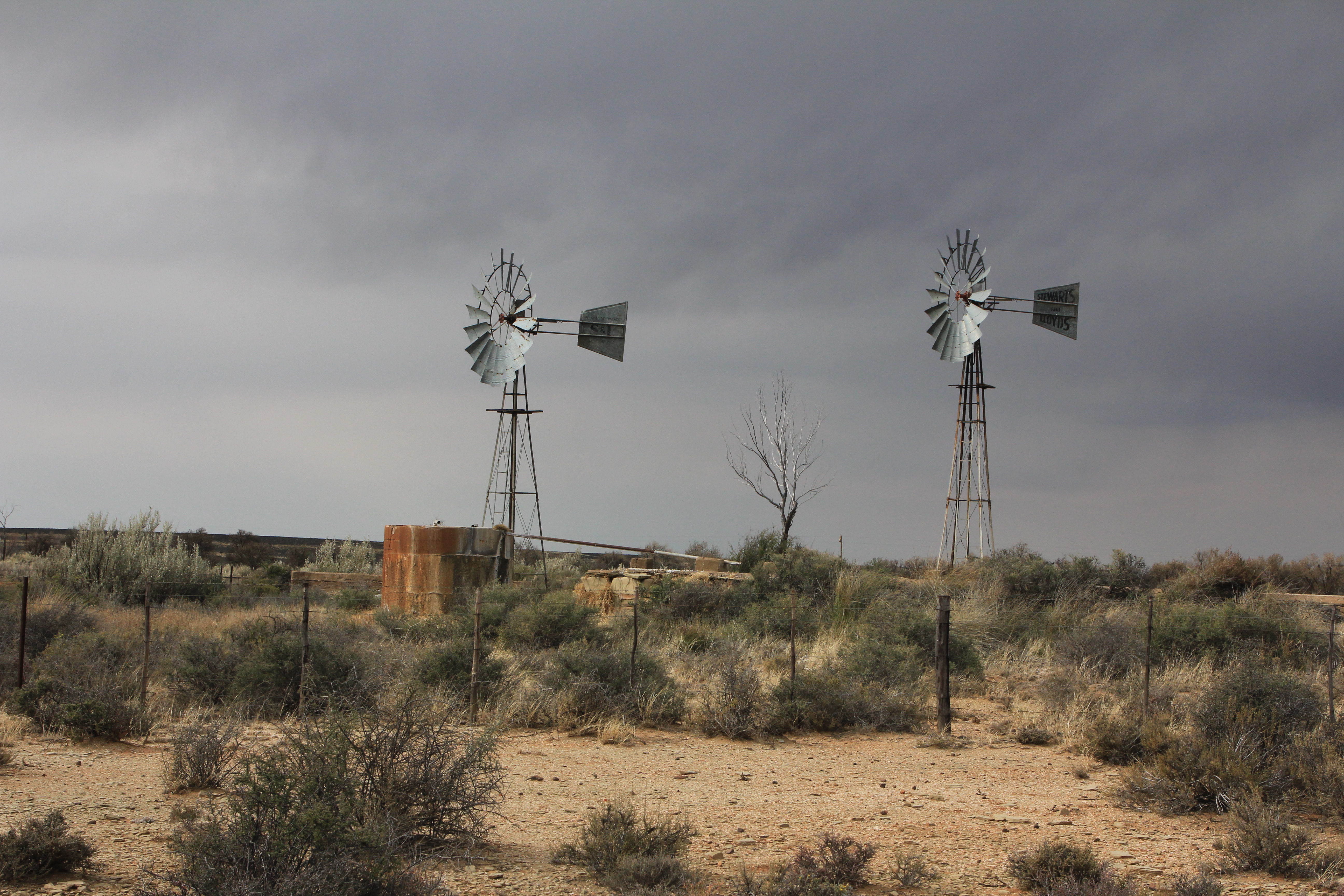 A brace of windmills in the dry Upper Karoo. Image: Chris Marais