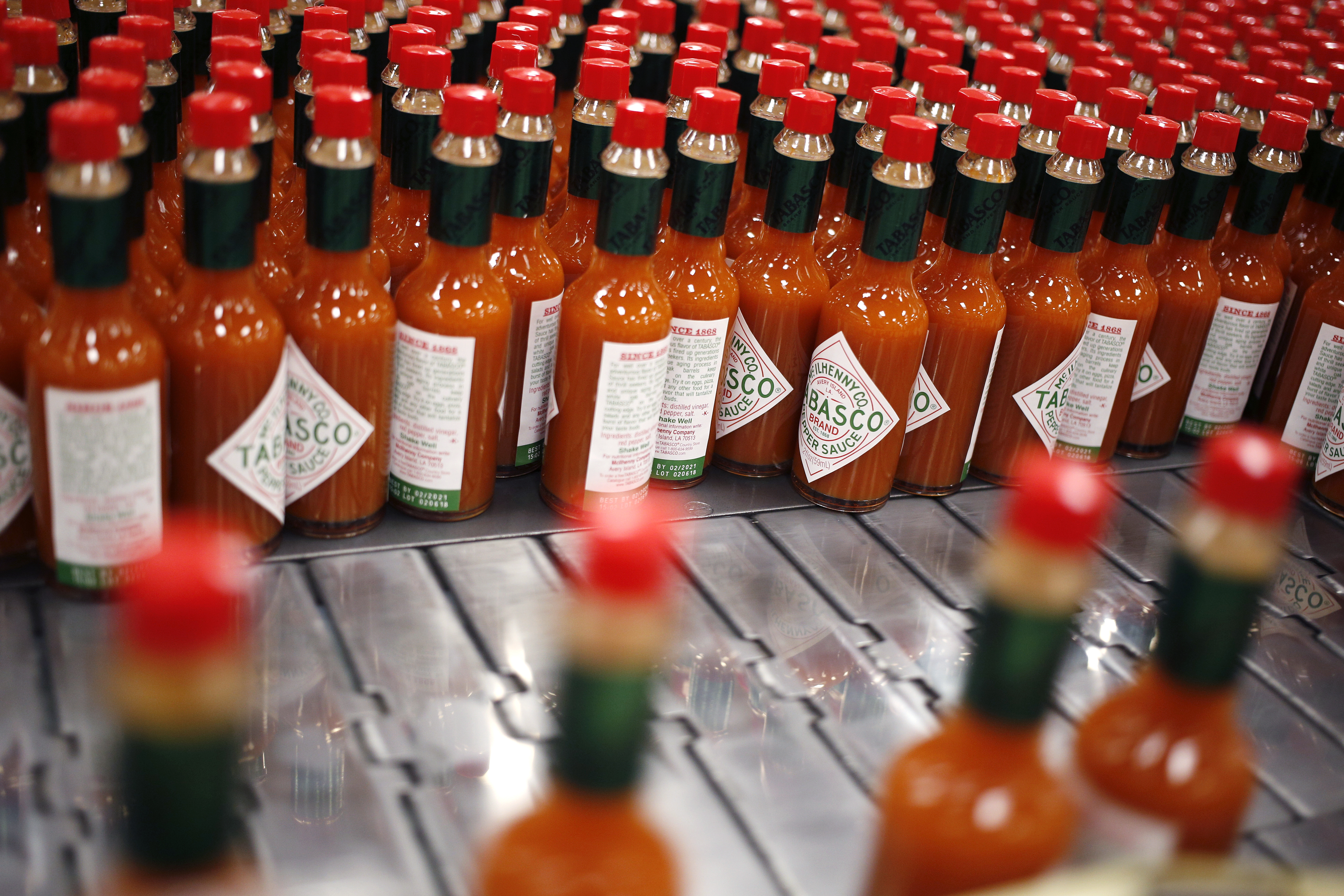 Bottles of Tabasco brand pepper sauce move down a production line at the McIlhenny Co. facility in Avery Island, Louisiana, U.S., on Tuesday, Feb. 6, 2018. Wholesale Inventories rose 0.4% in December, increasing to $612.1b from the prior month, according to the U.S. Census Bureau. Photographer: Luke Sharrett/Bloomberg via Getty Images