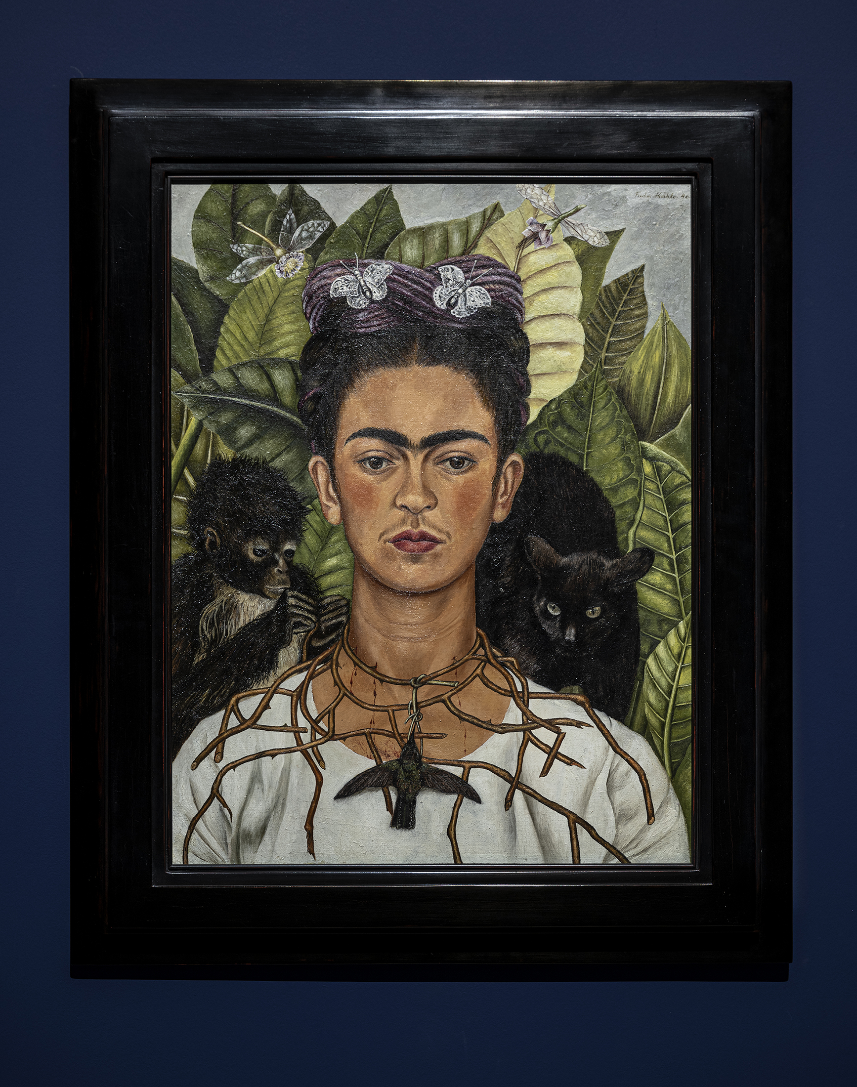 Installation view of Frida Kahlo, Self Portrait with Hummingbird and Thorn Necklace (1940). Collection Harry Ransom Center, The University of Texas at Austin, Nickolas Muray Collection of Modern Mexican Art. © Banco de México Diego Rivera & Frida Kahlo Museums Trust. Photo Graham De Lacy
