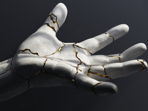 A ceramic hand with gold and kintsugi