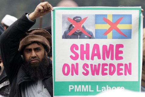 The Day in Pictures: Swedish politician burns the Koran, and Romanian activists protest for peace