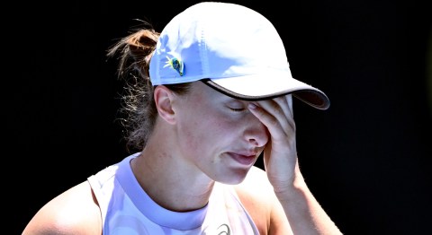 Top seed Świątek crashes out of Australian Open, Tsitsipas survives