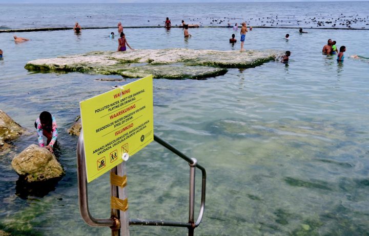 Some beachgoers undeterred by health warnings as Cape Town blames rolling blackouts for sewage spills