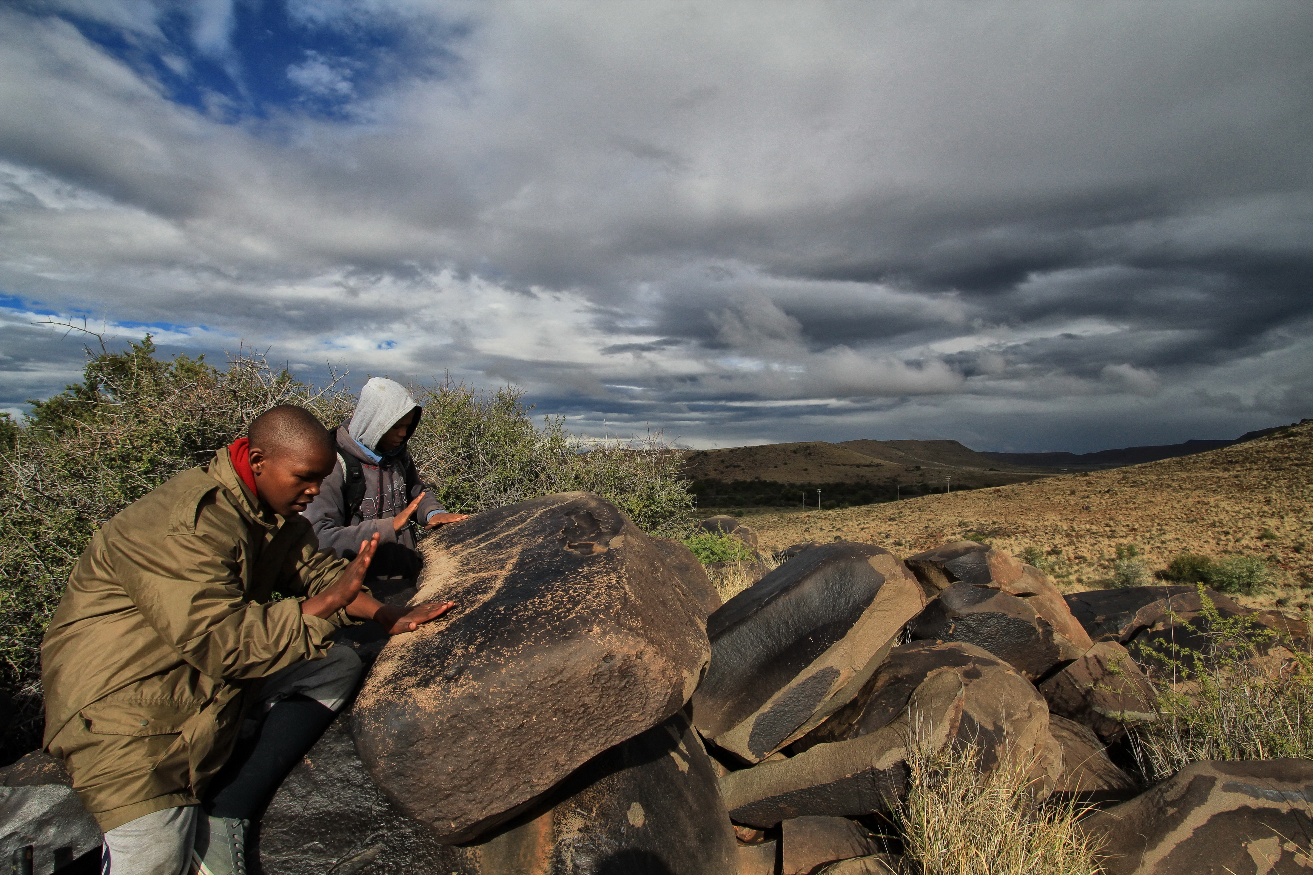 Drumming session – Elrico Adams and Shaun Gentels beating on a gong rock on the heights above Nelspoort. Image: Chris Marais