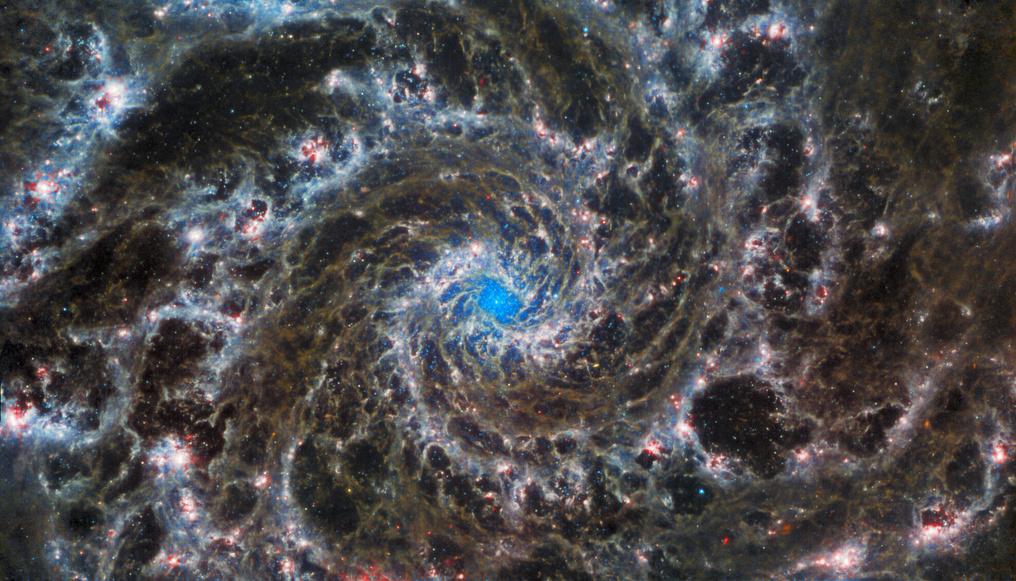 This image from the NASA/ESA/CSA James Webb Space Telescope shows the heart of M74, otherwise known as the Phantom Galaxy. Webb’s sharp vision has revealed delicate filaments of gas and dust in the grandiose spiral arms which wind outwards from the centre of this image. A lack of gas in the nuclear region also provides an unobscured view of the nuclear star cluster at the galaxy's centre. M74 is a particular class of spiral galaxy known as a ‘grand design spiral’, meaning that its spiral arms are prominent and well-defined, unlike the patchy and ragged structure seen in some spiral galaxies. ESA/Webb, NASA & CSA, J. Lee and the PHANGS-JWST Team. Acknowledgement: J. Schmidt
