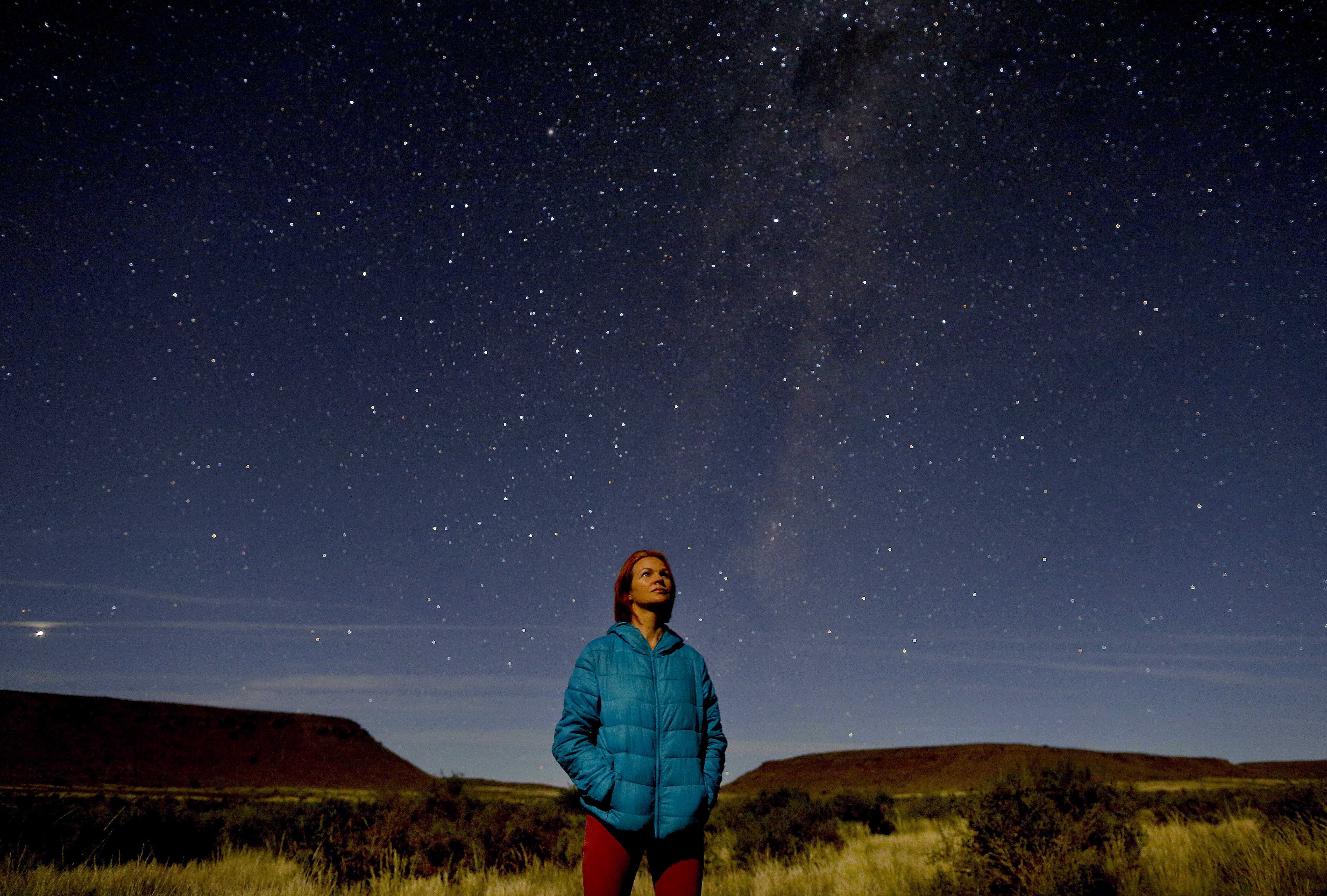 A tourist looks skywards at the southern constellation of stars outside Calvinia, South Africa, 22 April 2018. The huge open spaces of the Karoo Desert are perfect for star gazing as there is no light pollution from cities or towns to interfere. EPA-EFE/KIM LUDBROOK