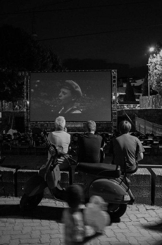 'Watching Each Other'. During the DokuFest film festival in Kosovo, films being shown at one of the cinemas set up in the city are watched without a ticket. © Suer Celina, Kosovo, Shortlist, Regional Awards, Sony World Photography Awards 2023