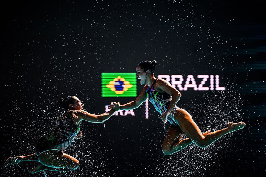 'Convergence'. Team Brazil competes in the preliminaries of the women’s team highlight artistic swimming event during the 2022 World Aquatics Championships at the Alfréd Hajós National Swimming Stadium, Budapest. © Dávid Balogh, Hungary, Shortlist, Regional Awards, Sony World Photography Awards 2023
