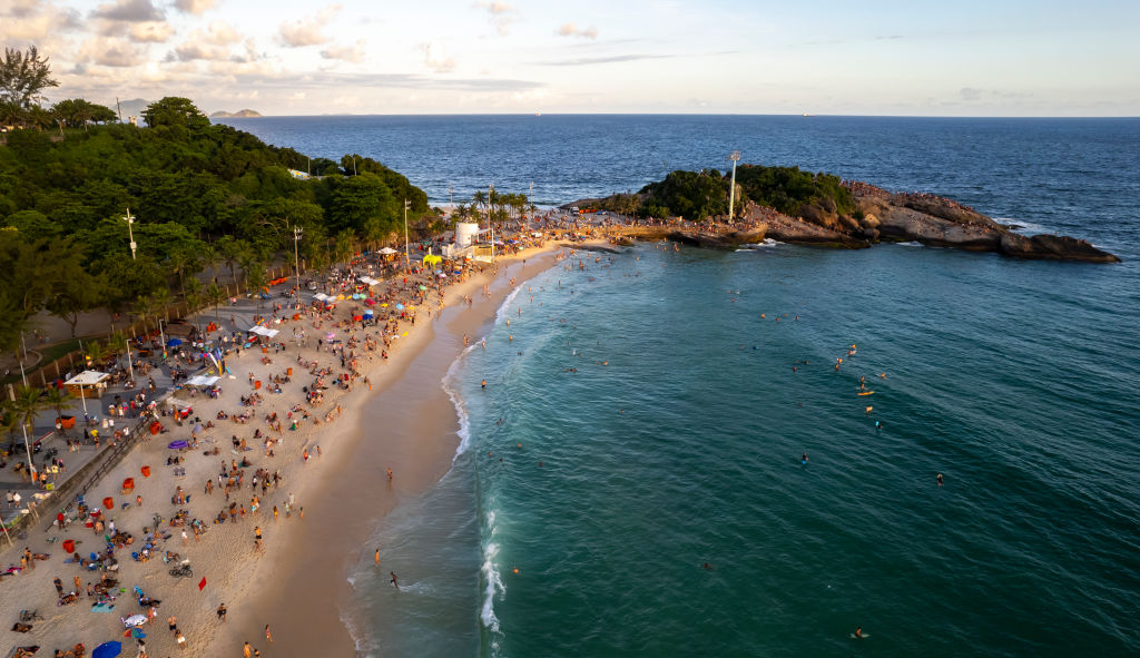 RIO DE JANEIRO, BRAZIL - JANUARY 26: In an aerial view, Tourists and locals enjoy the sunset during the summer at Arpoador beach on January 26, 2023 in Rio de Janeiro, Brazil. (Photo by Buda Mendes/Getty Images)
