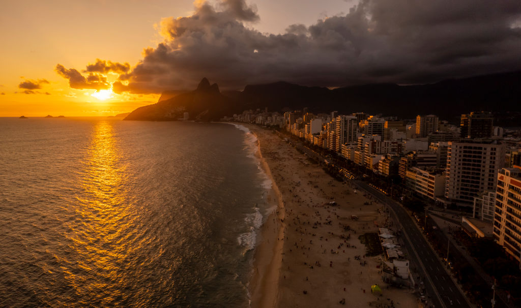 RIO DE JANEIRO, BRAZIL - JANUARY 26: In an aerial view, Tourists and locals enjoy the sunset during the summer at the famous Ipanema beach on January 26, 2023 in Rio de Janeiro, Brazil. (Photo by Buda Mendes/Getty Images)